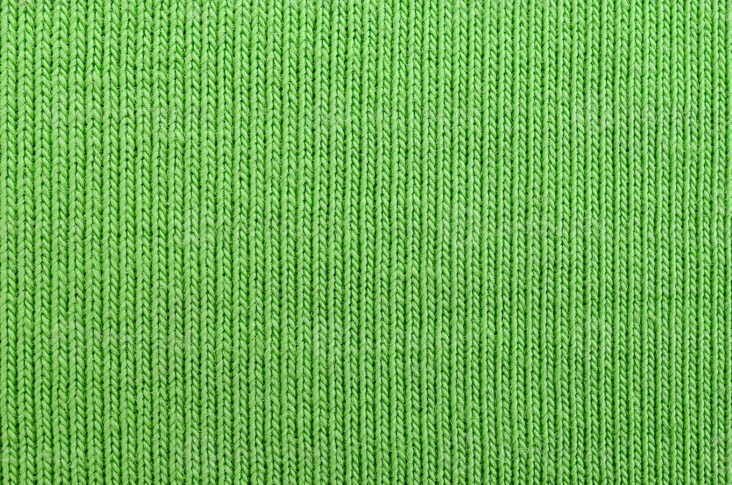 The texture of the fabric is bright green. Material for making shirts and blouses photo
