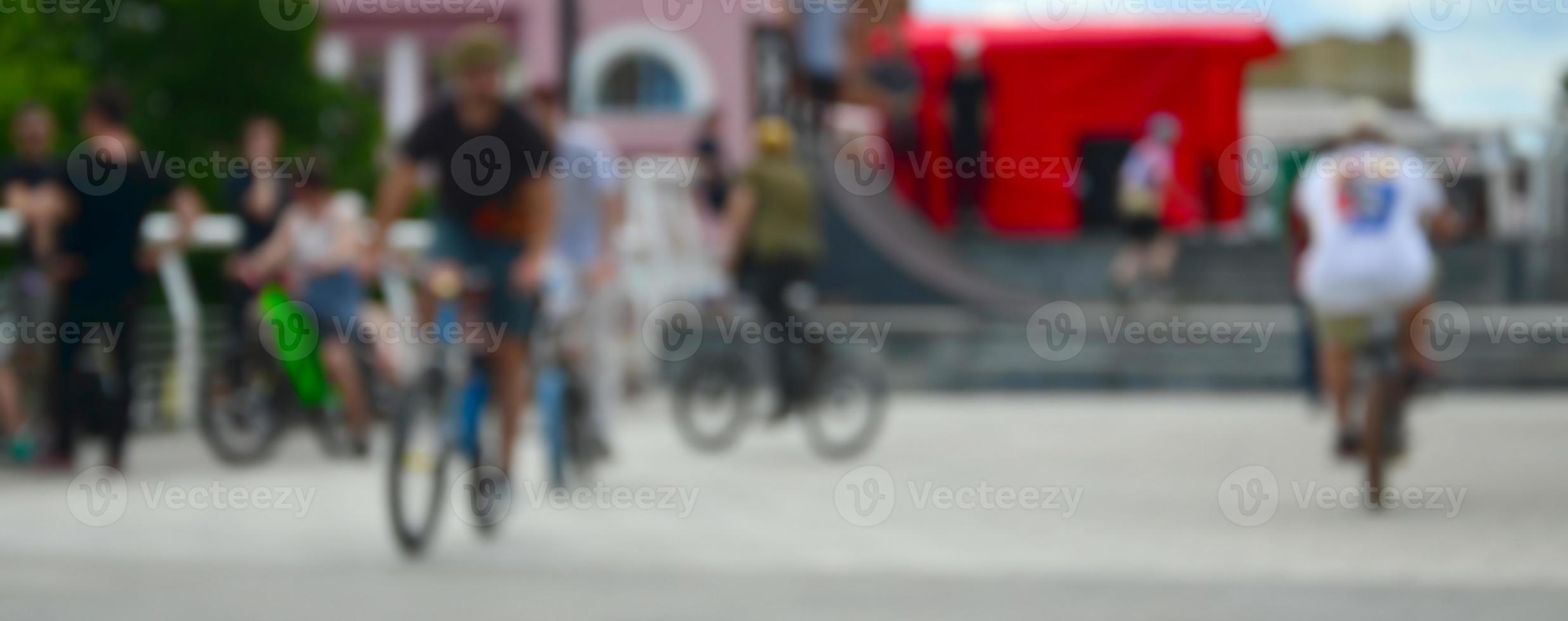 Defocused image of a lot of people with bmx bikes. Meeting of fans of extreme sports photo