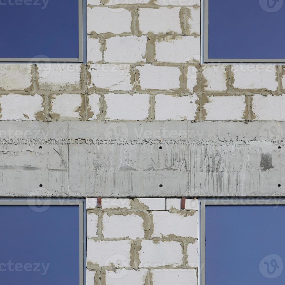 Fragment of an unfinished structure of a multi-storey building made of large concrete bricks photo