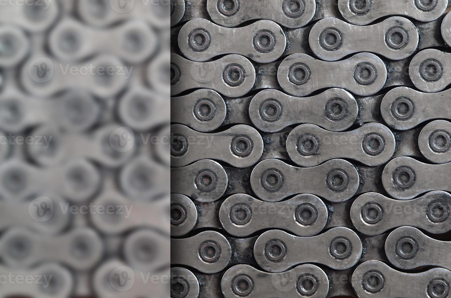 Dirty and oily chain from a mountain bike lying on a wooden table in a bicycle shop photo