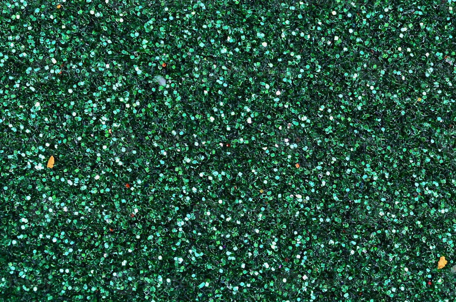 Colorful defocused emerald green background with glittering and sparkling spots photo