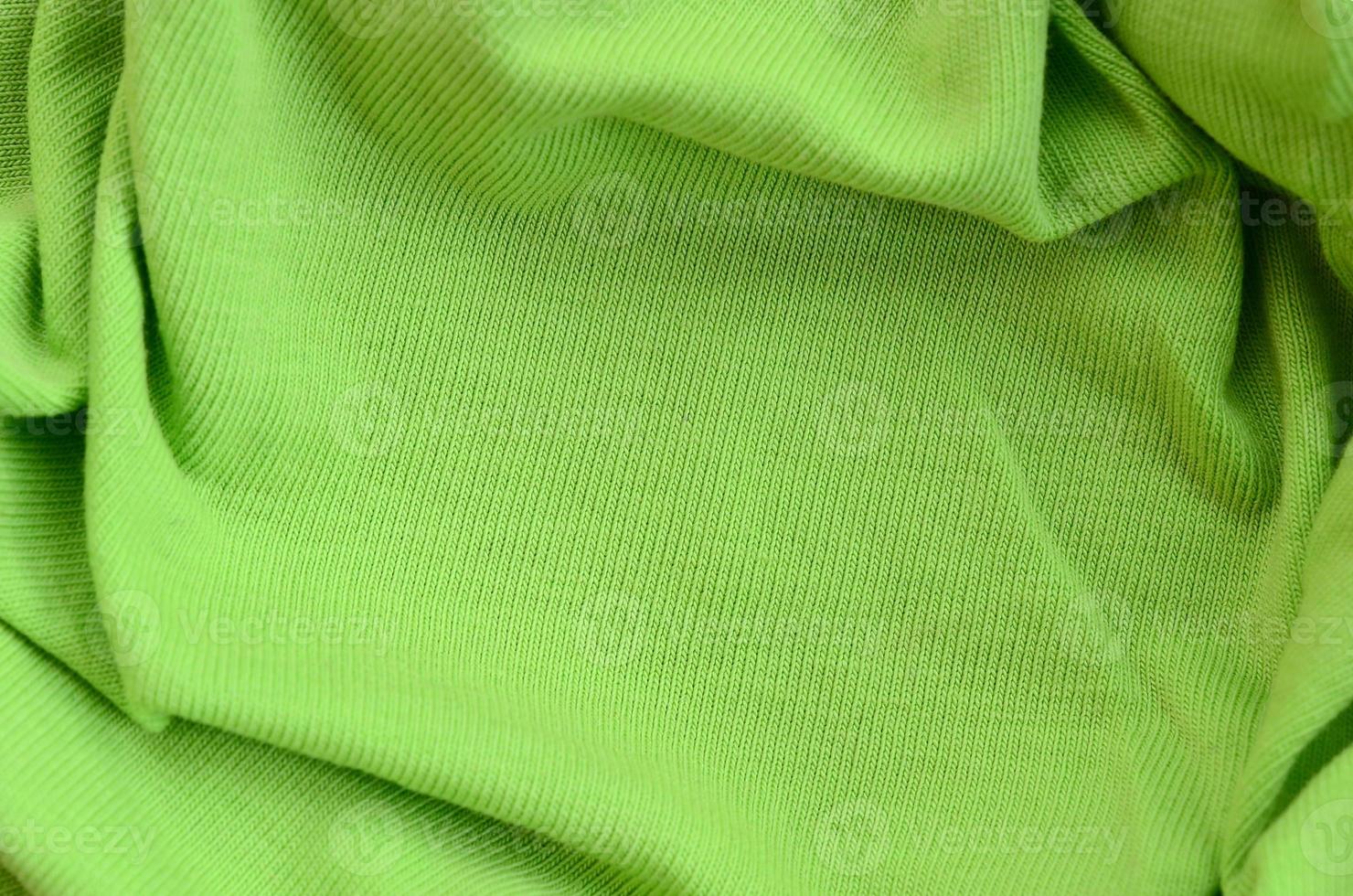 The texture of the fabric is bright green. Material for making shirts and blouses photo