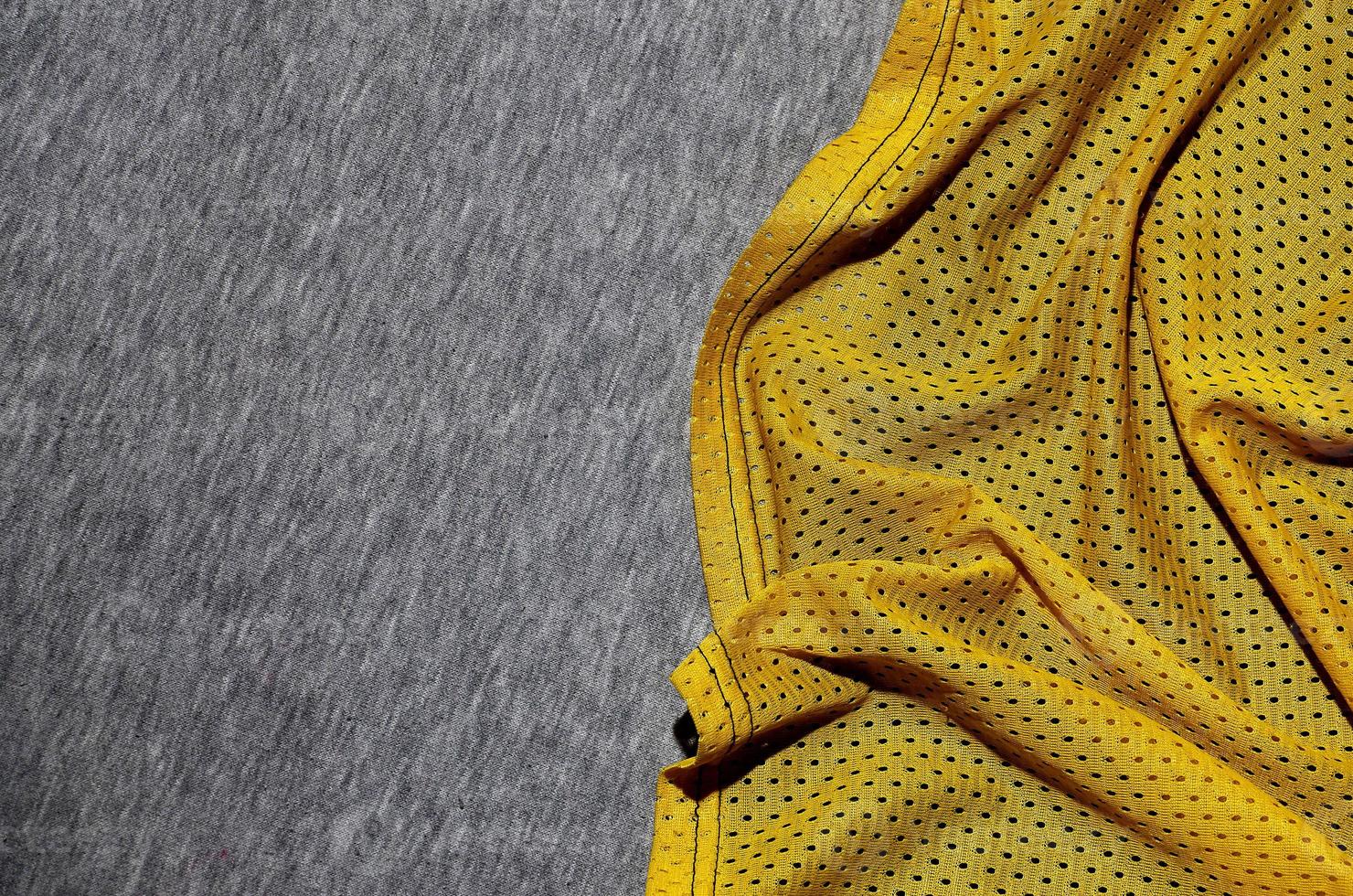 Top view of cloth textile surface. Close-up rumpled heater and knitted fabric texture with a thin striped pattern. Sport clothing fabric texture. Colored basketball shirt and heater hoodie photo