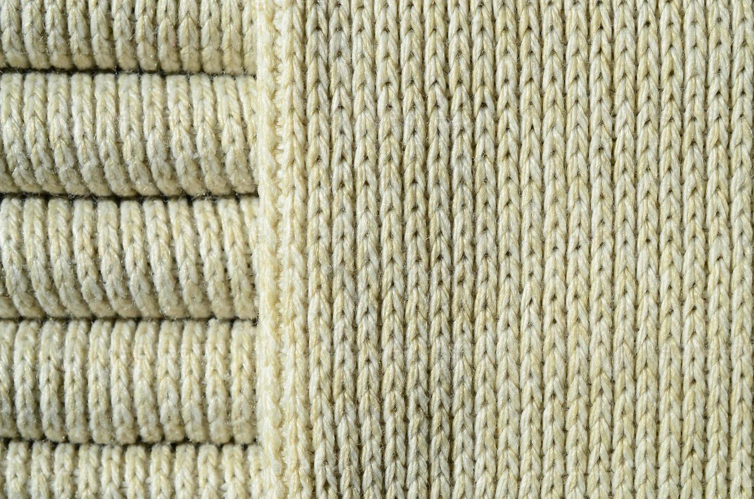 Composition of a soft yellow knitted sweater. Macro texture of bindings in yarns photo