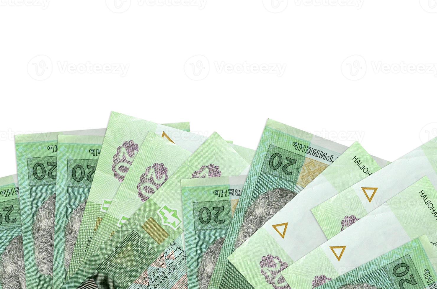 20 Ukrainian hryvnias bills lies on bottom side of screen isolated on white background with copy space. Background banner template photo