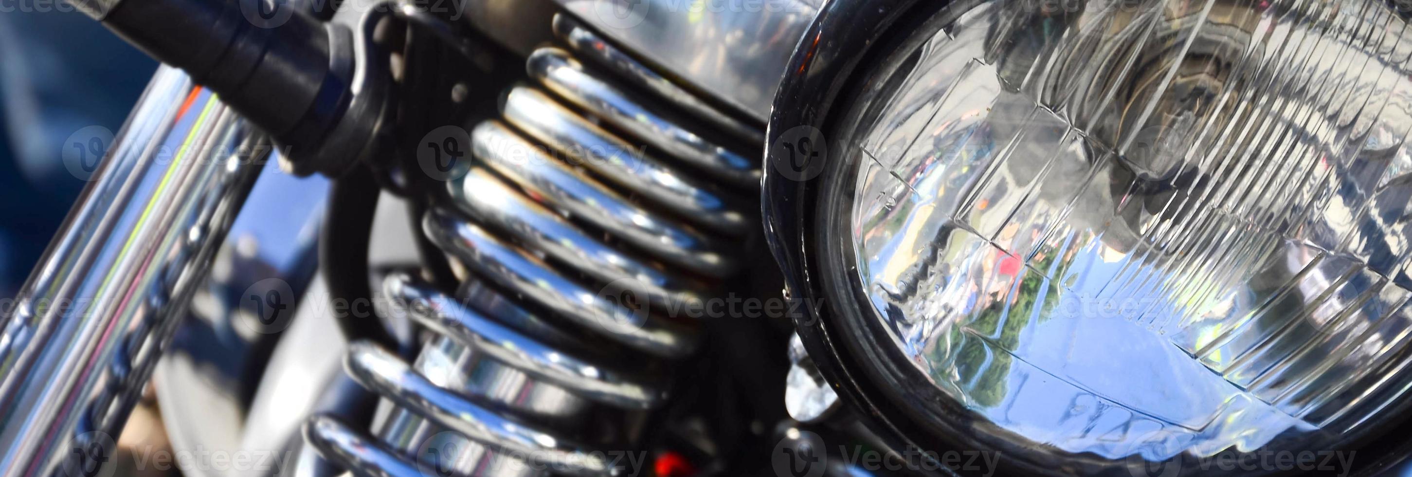 Fragment of chromed shiny lamp of old classic motorbike photo