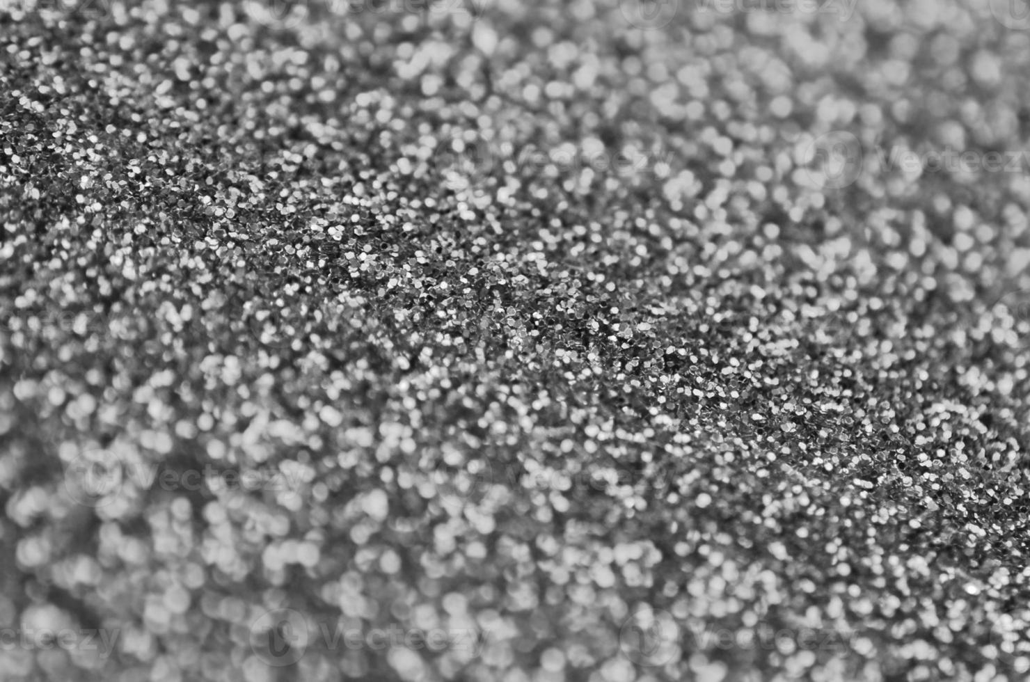 Silver decorative sequins. Background image with shiny bokeh lights from small elements photo