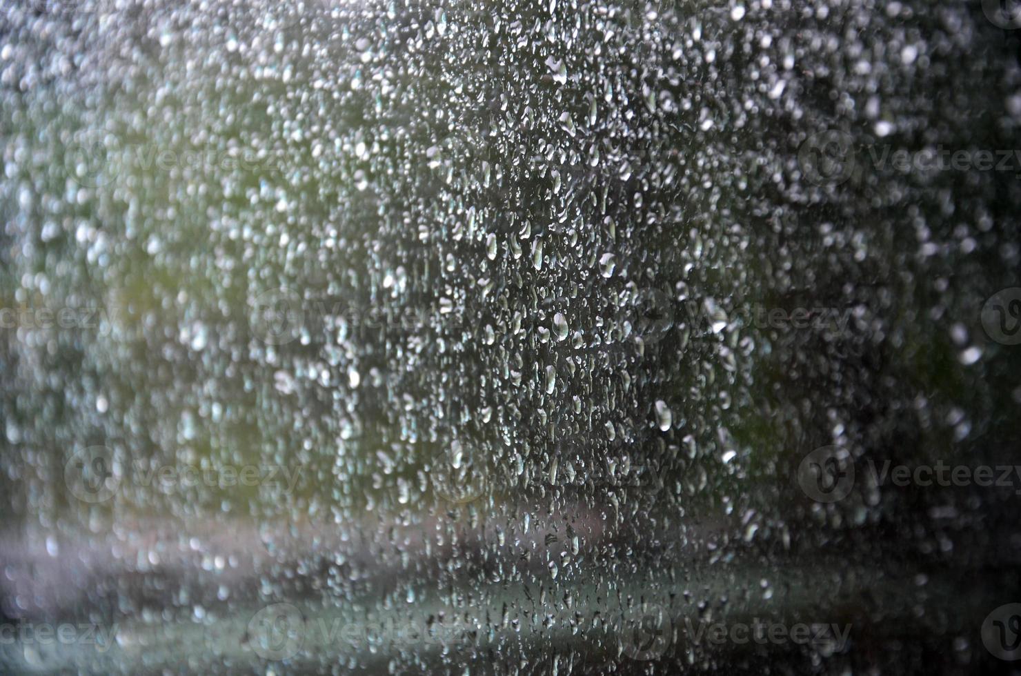 Background image of rain drops on a glass window. Macro photo with shallow depth of field