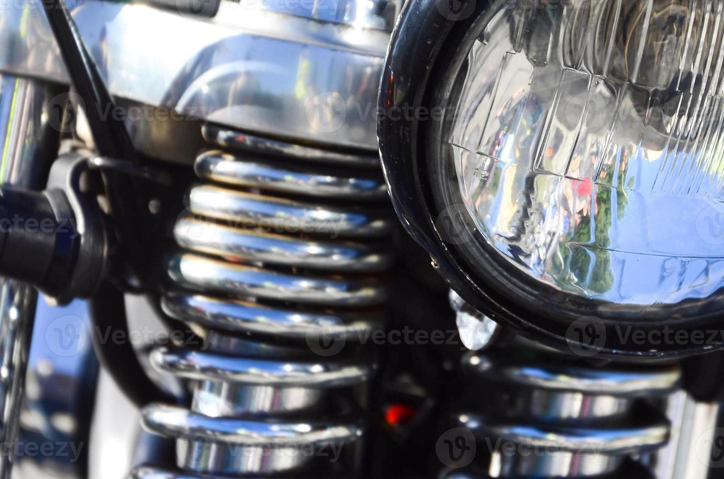 Fragment of chromed shiny lamp of old classic motorbike photo