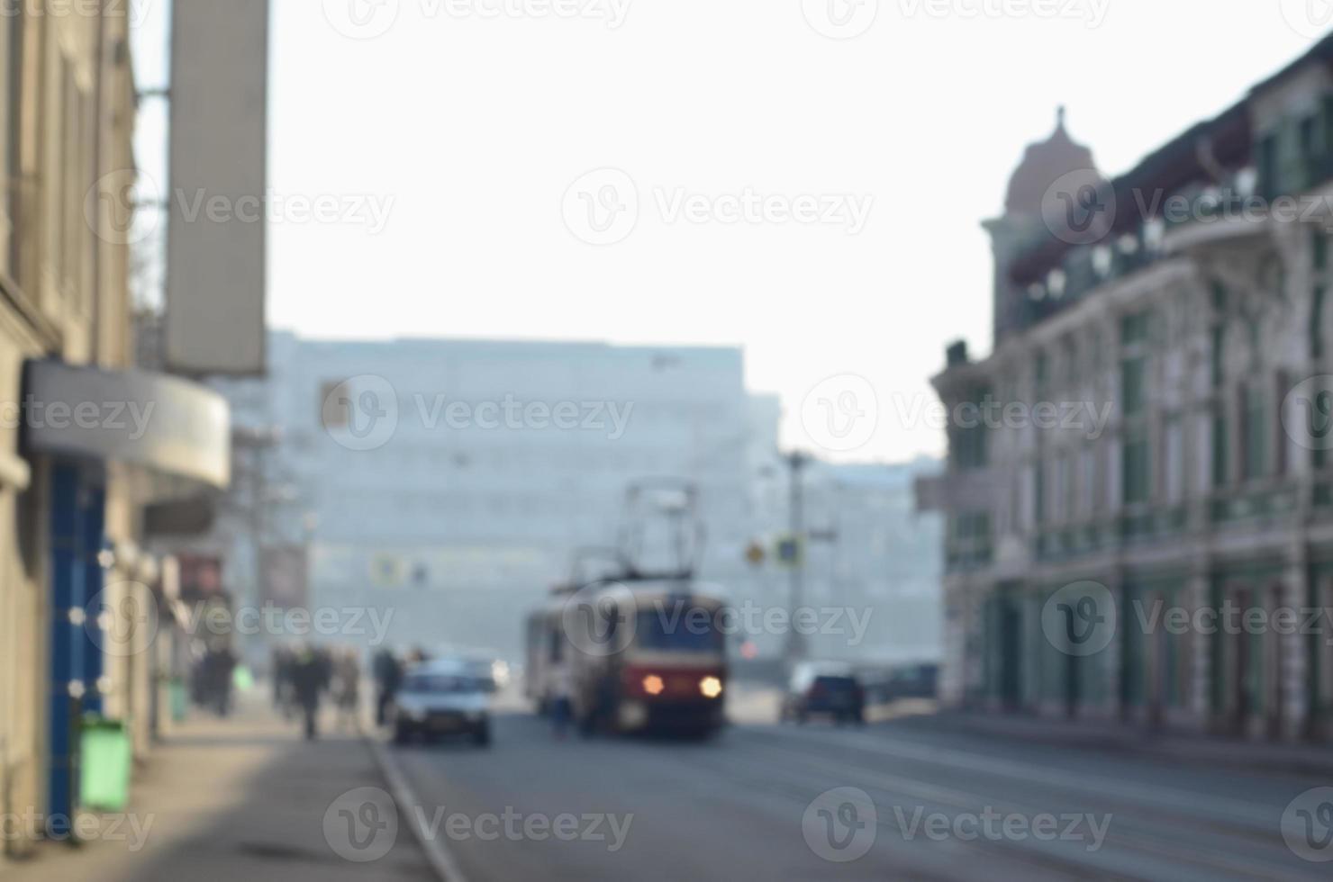 Blurred landscape of highway with cars and tram in foggy morning photo