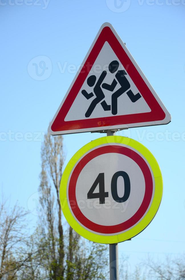 Road sign with the number 40 and the image of the children who run across the road photo