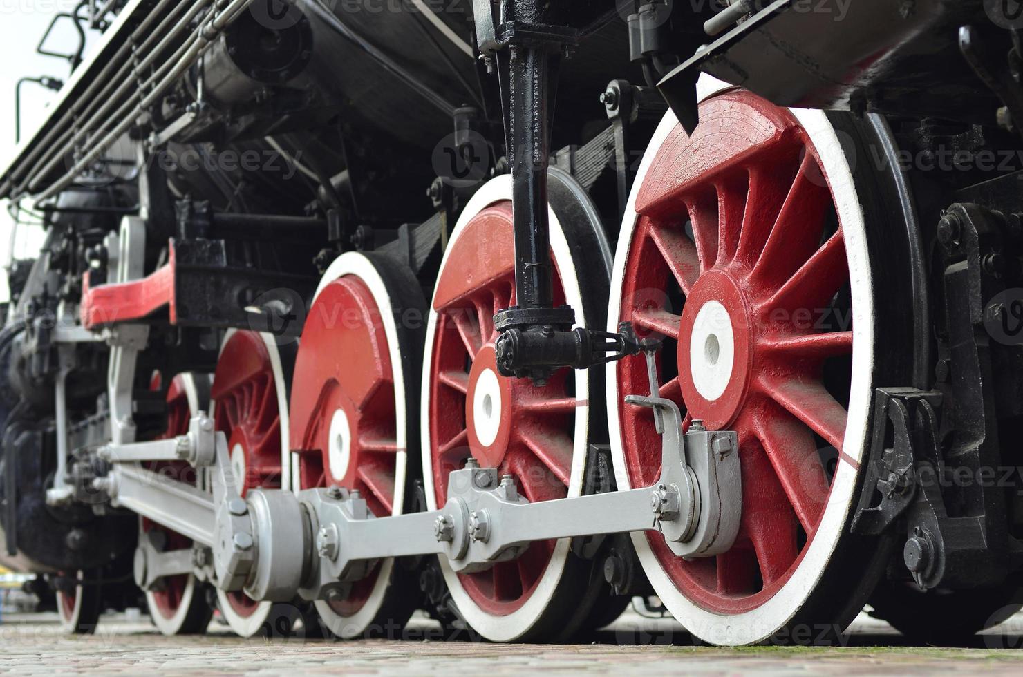 Red wheels of steam train photo