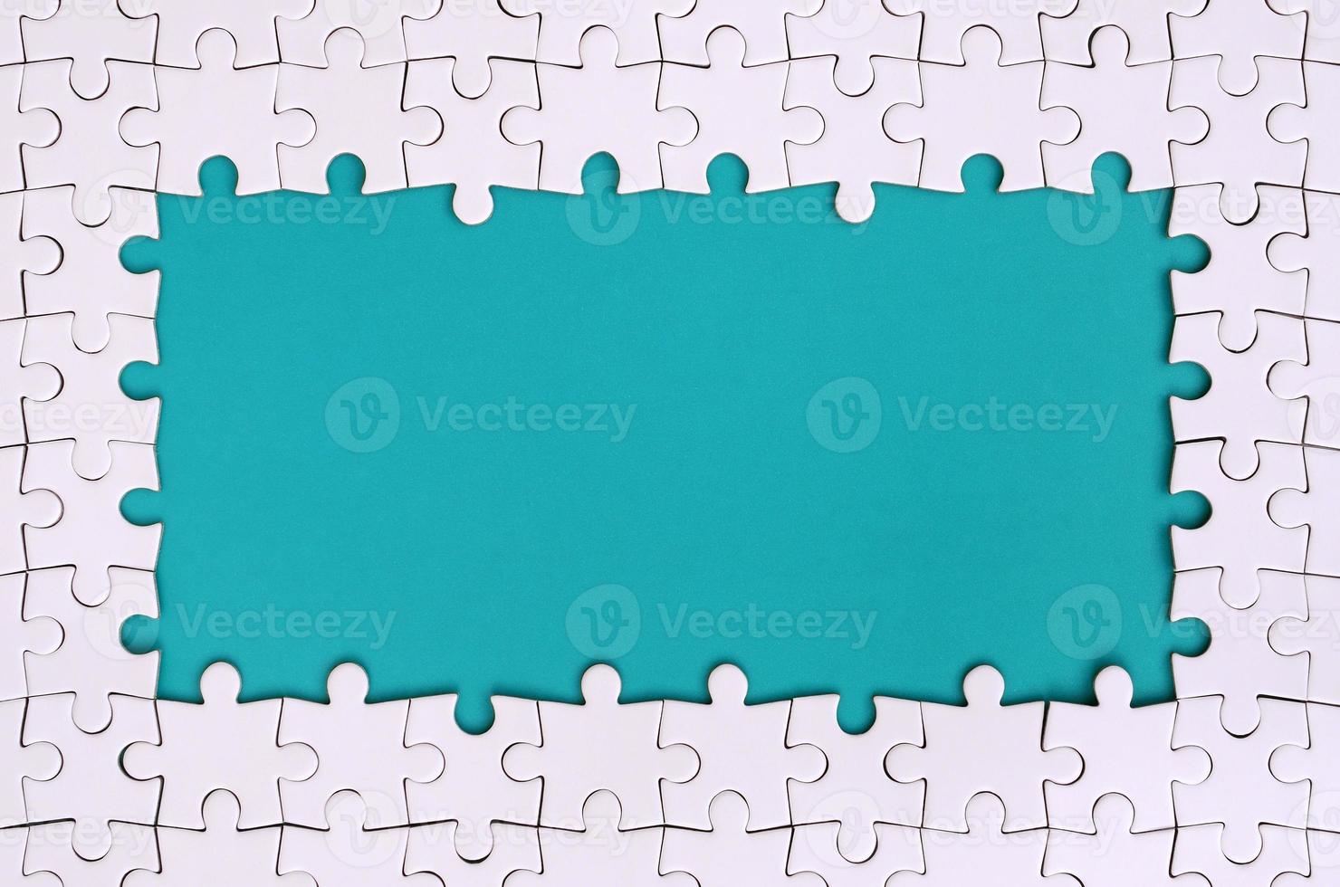 Framing in the form of a rectangle, made of a white jigsaw puzzle around the blue space photo