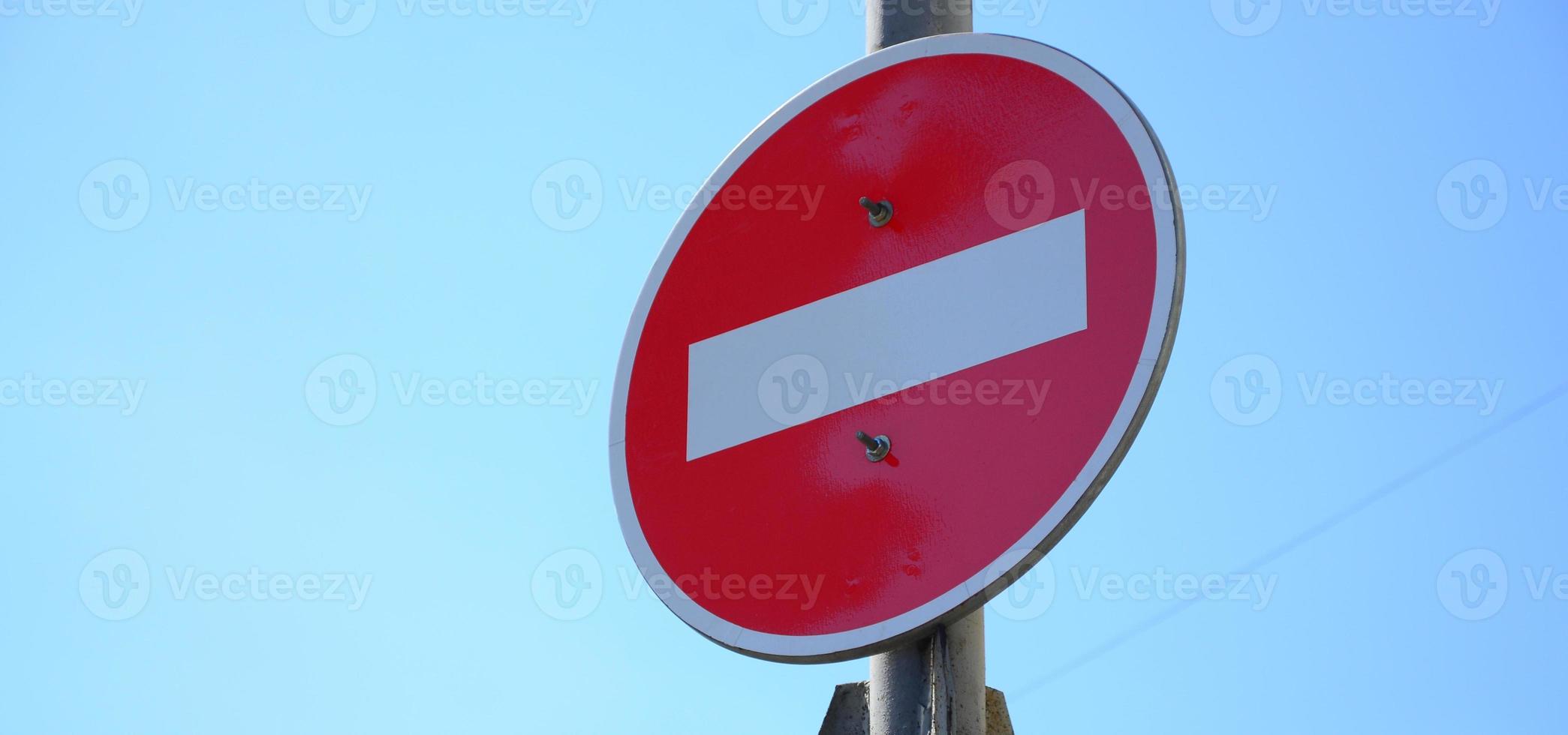 Road sign in the form of a white rectangle in a red circle. No entry photo