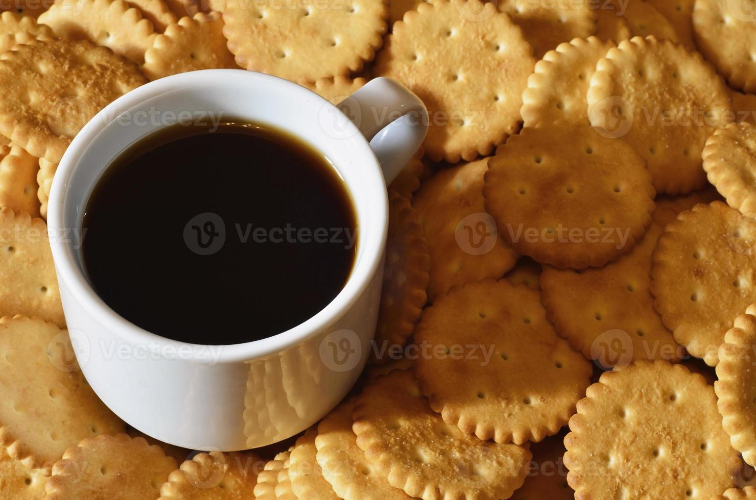 Small coffee cup and salted cracker photo
