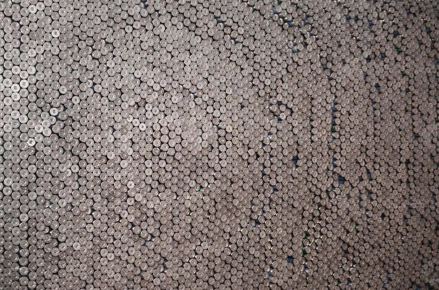 Pattern of 12 gauge cartridges for shotgun bullets. Shells for hunting rifle close up. Backdrop for shooting range or ammunition trade concepts photo