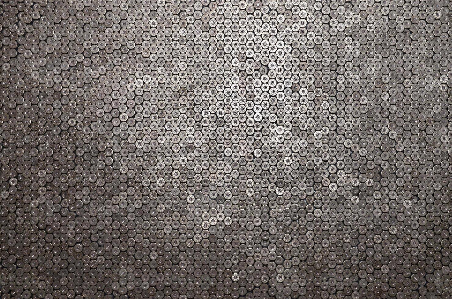 Pattern of 12 gauge cartridges for shotgun bullets. Shells for hunting rifle close up. Backdrop for shooting range or ammunition trade concepts photo