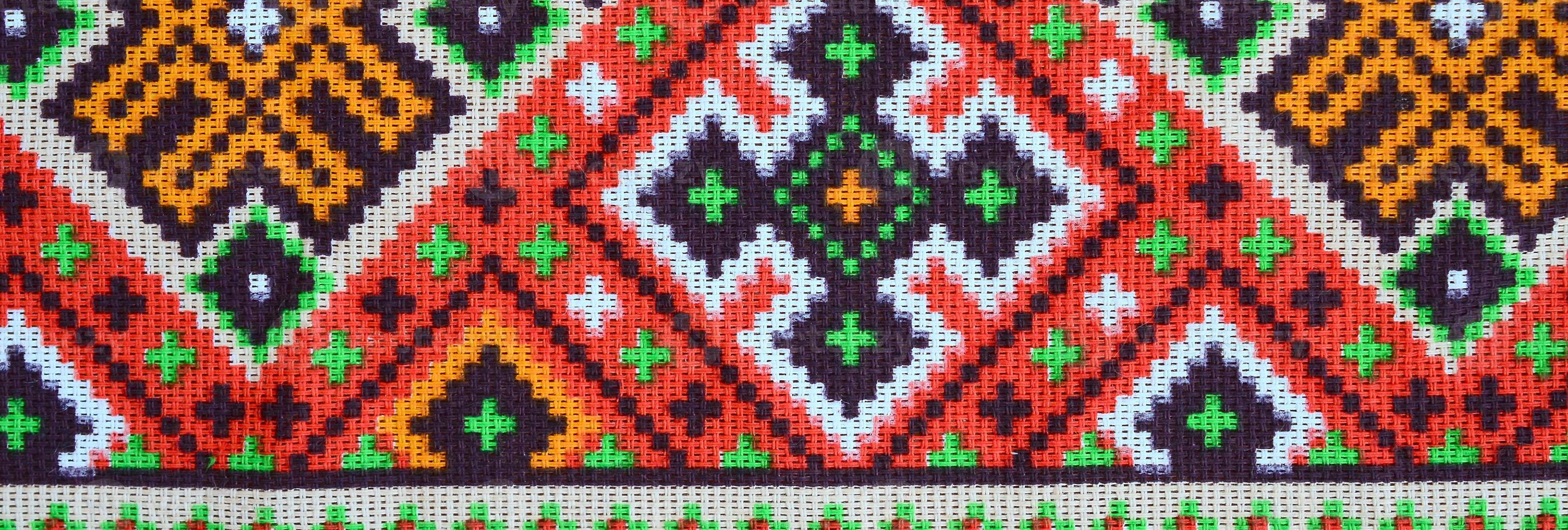 Traditional Ukrainian folk art knitted embroidery pattern on textile fabric photo