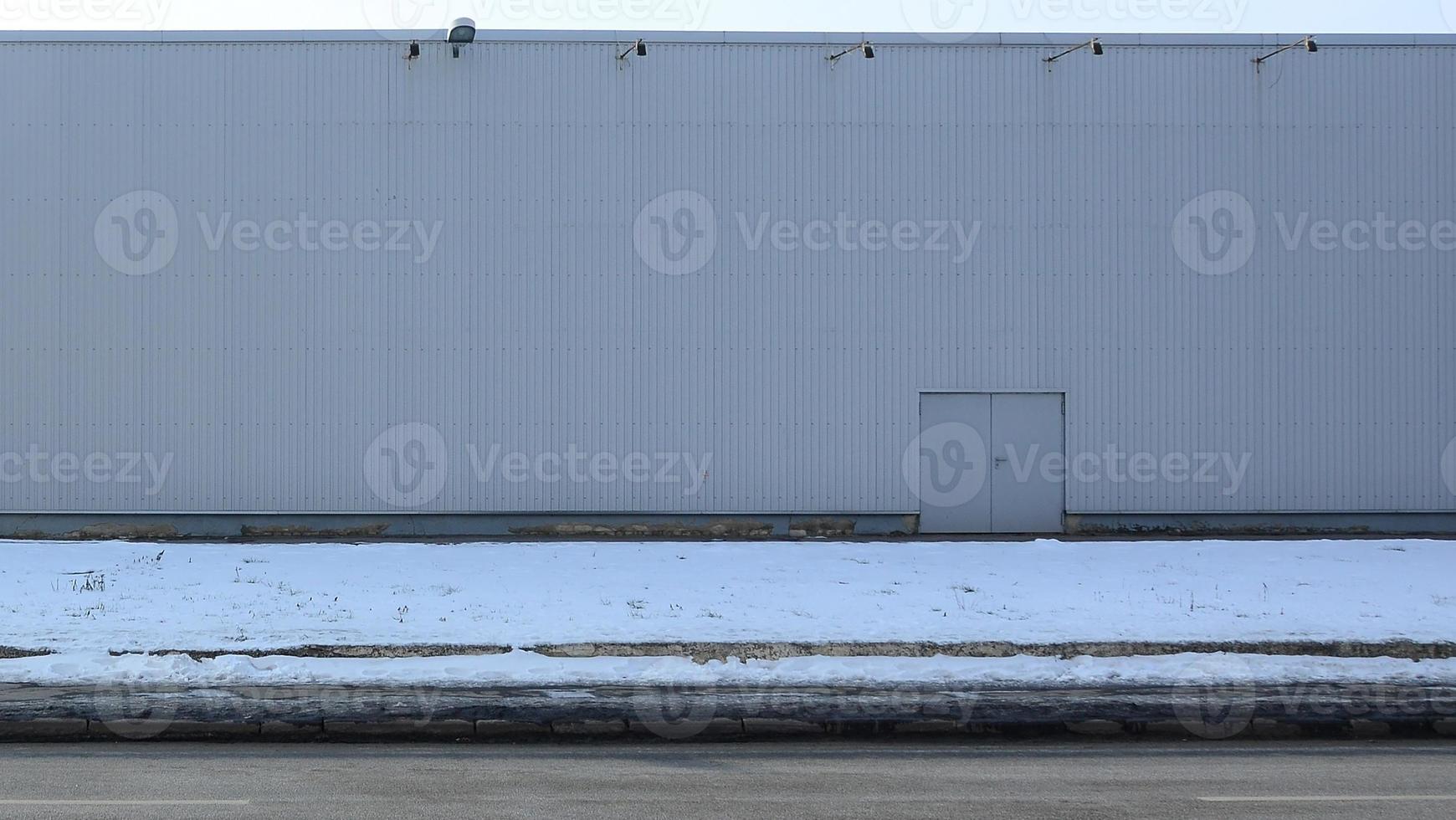 Texture of a high metal wall of an industrial building without windows photo