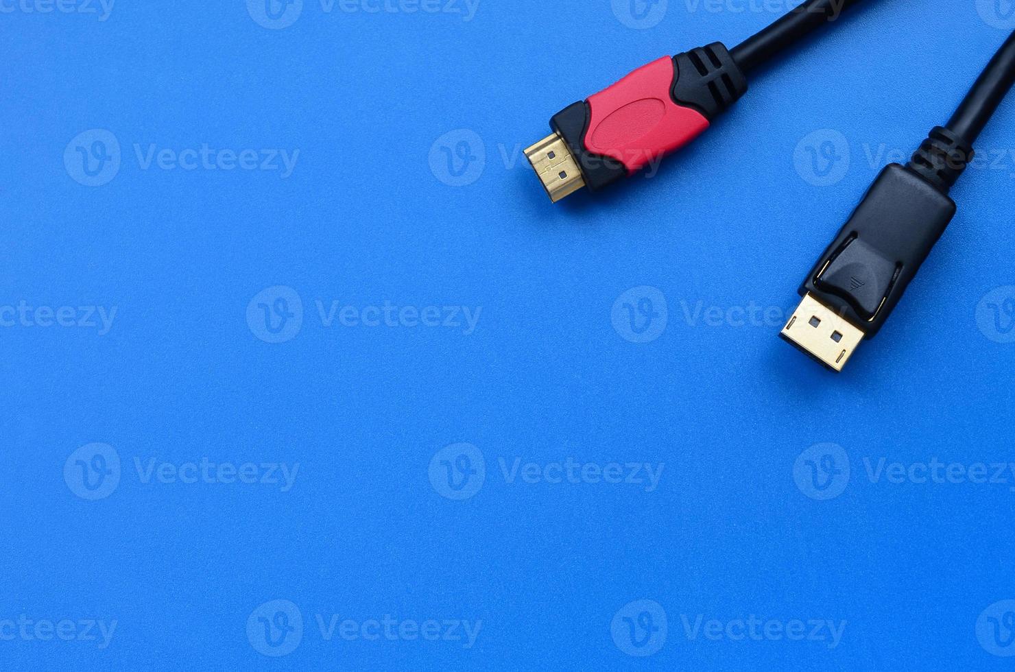 Audio video HDMI computer cable plug and 20-pin male DisplayPort gold plated connector for a flawless connection on a blue background photo