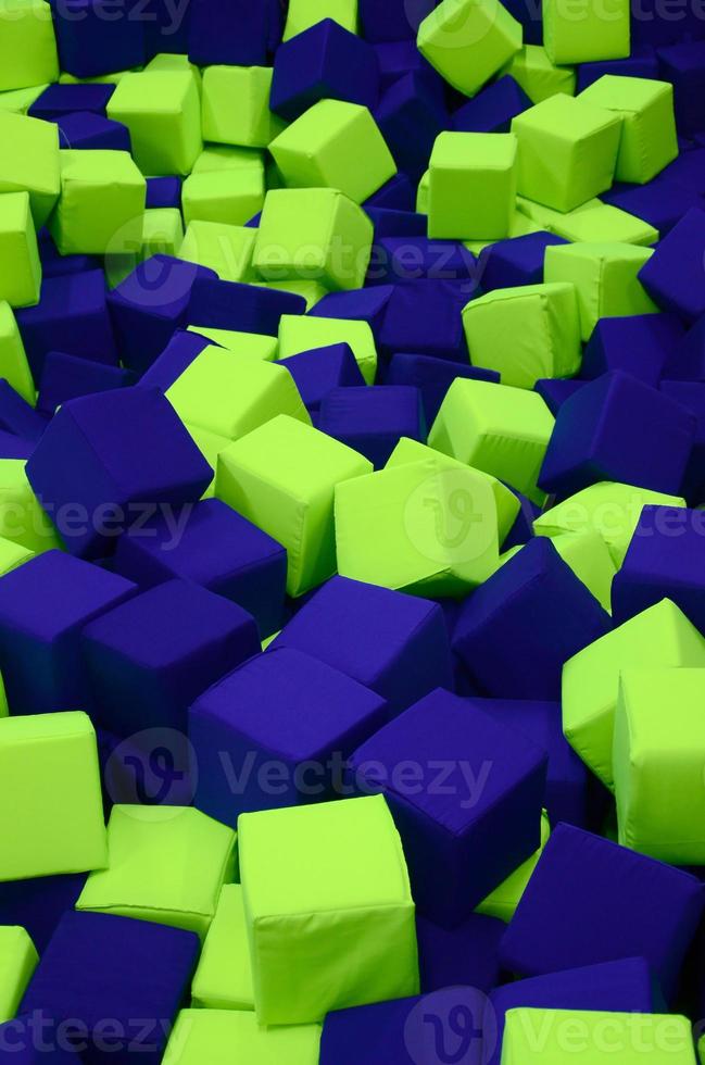 Many colorful soft blocks in a kids' ballpit at a playground photo