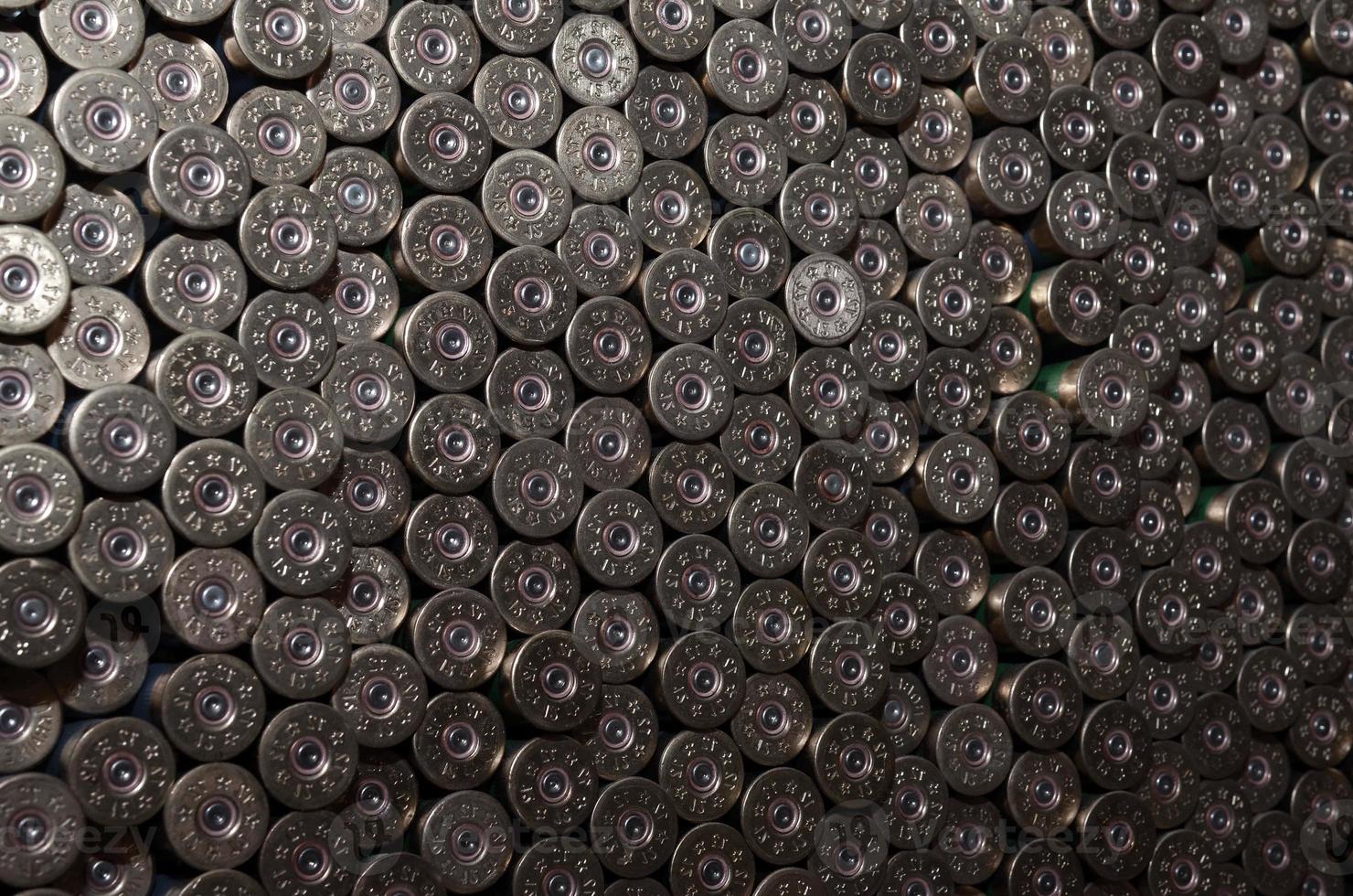 Pattern of 12 gauge cartridges for shotgun bullets. Shells for hunting rifle close up. Backdrop for shooting range or ammunition trade concepts photo