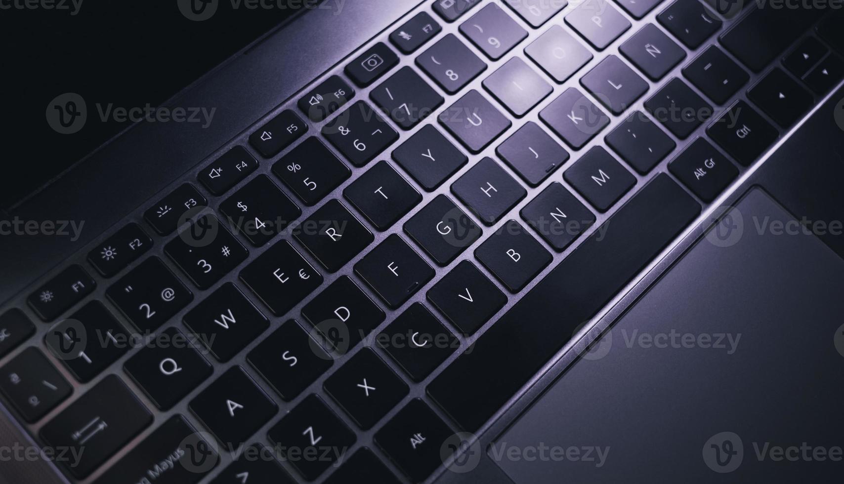 Top view of laptop keyboard. Workplace. Work from home. Office desk. photo