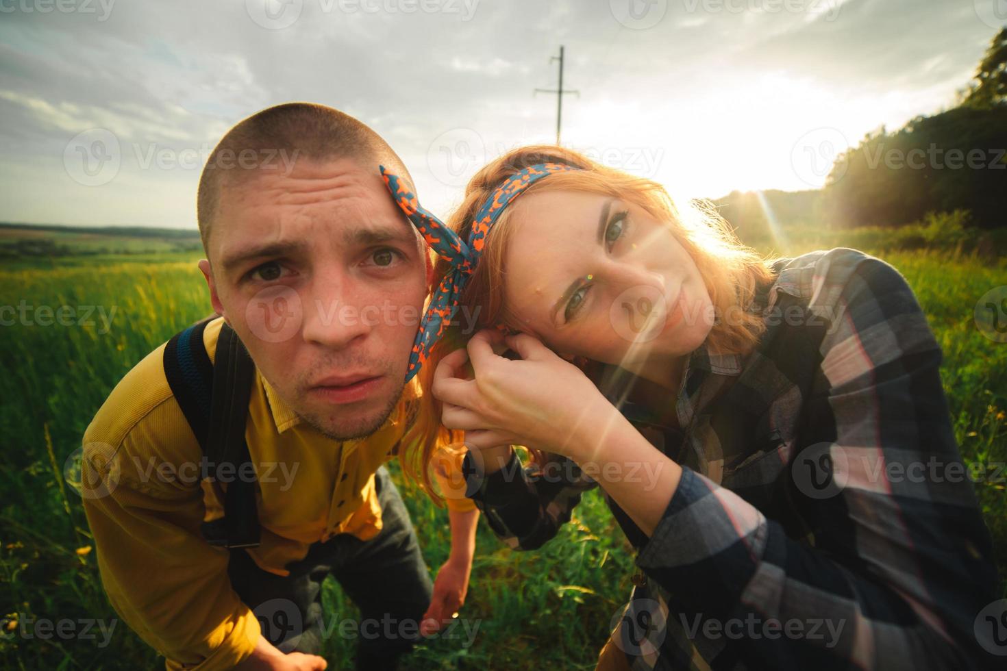 Playful happy handsome couple having while walking in woods. tourists in the mountains. Adventure in nature concept. photo