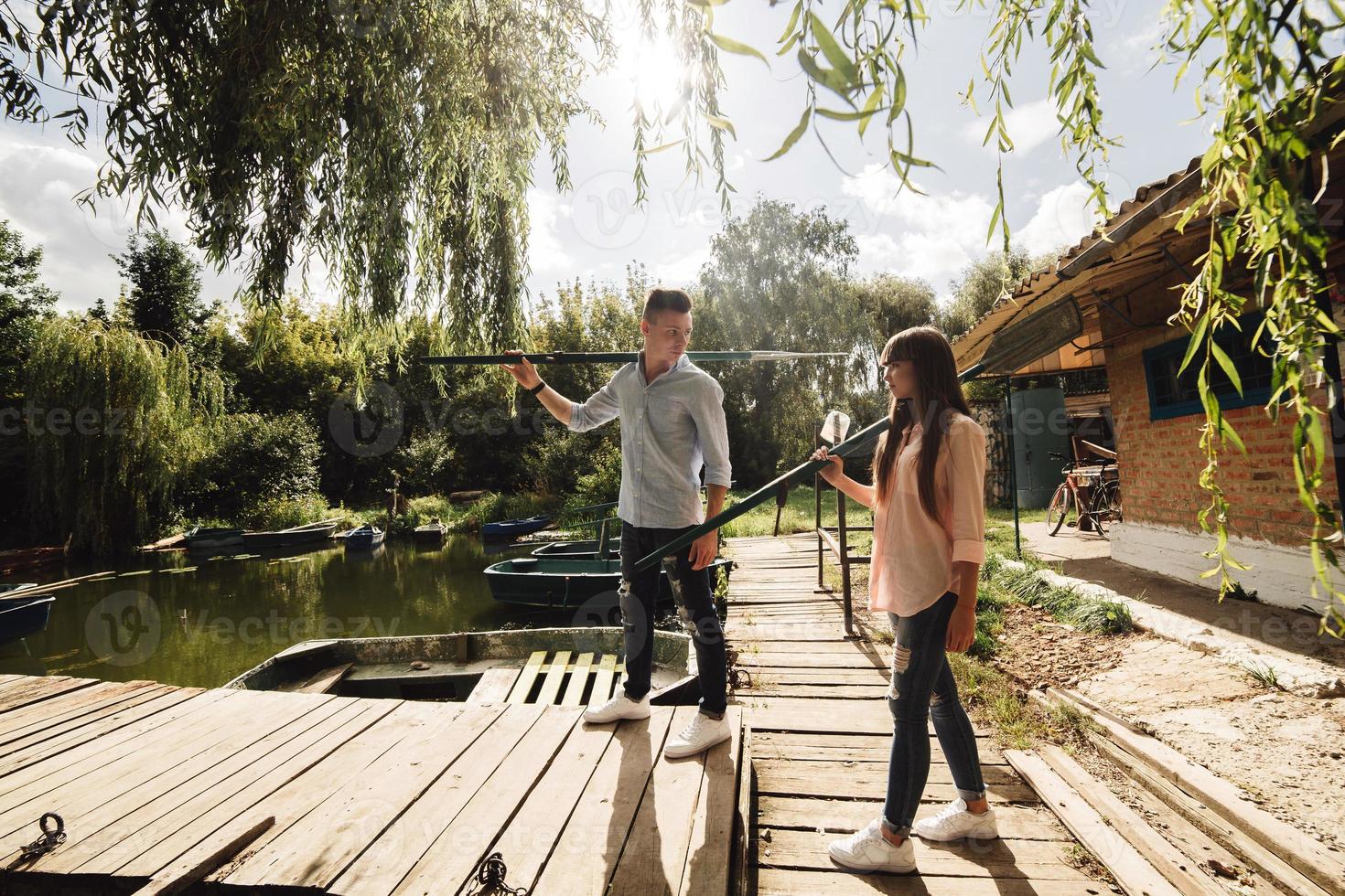 Cute couple walking near water. Girl in a white shirt. Pair by the river. Loving young couple near the river with boats. love without borders. selective focus photo