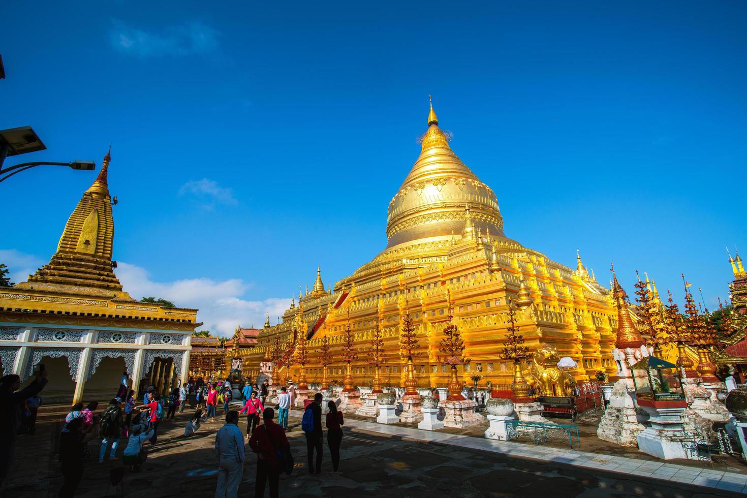 Bagan, Mandalay region, Myanmar - January 9, 2019 - Tourists visit at Shwezigon Pagoda, or Shwezigon Paya, a Buddhist temple located in Nyaung-U, a town near Bagan photo
