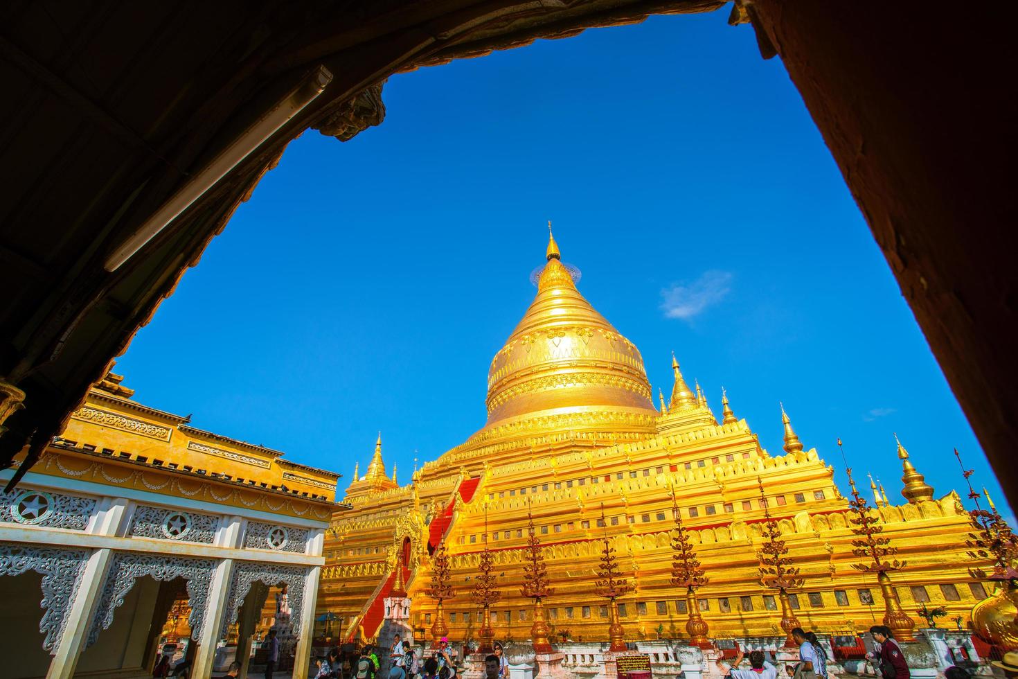 Bagan, Mandalay region, Myanmar - January 9, 2019 - Tourists visit at Shwezigon Pagoda, or Shwezigon Paya, a Buddhist temple located in Nyaung-U, a town near Bagan photo