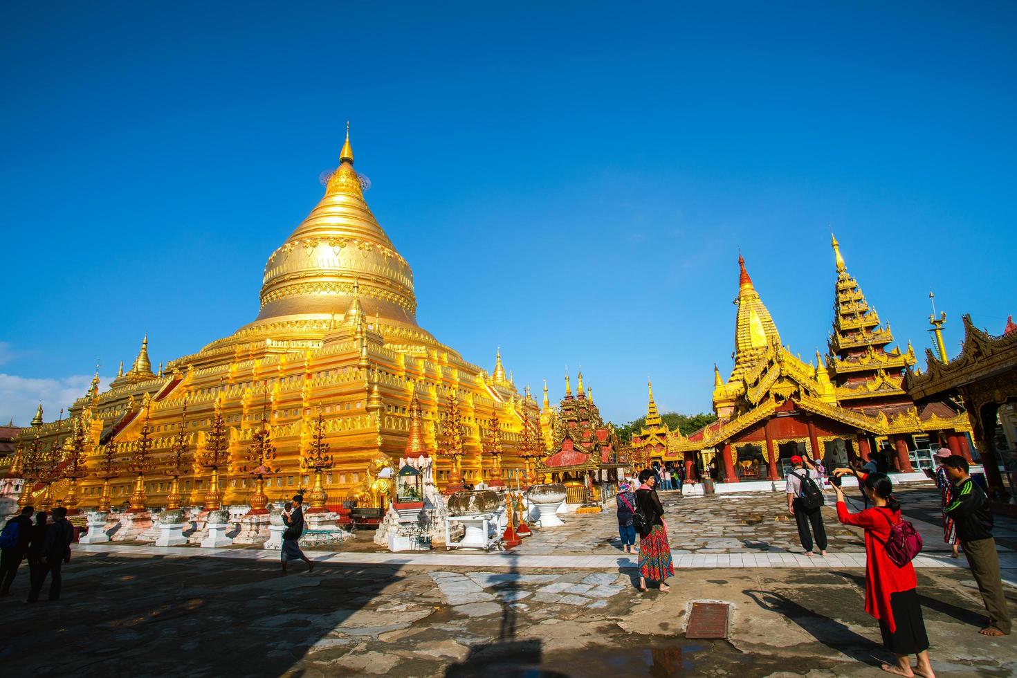 Bagan, Mandalay region, Myanmar - January 9, 2019 - Tourists visit at Shwezigon Pagoda, or Shwezigon Paya, a Buddhist temple located in Nyaung-U, a town near Bagan photo