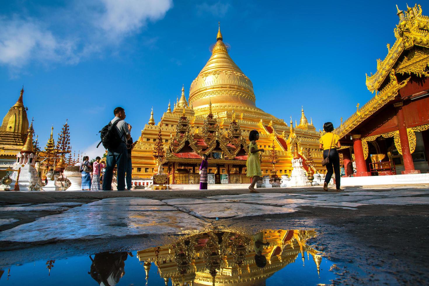 Bagan, Mandalay region, Myanmar - January 9, 2019 - Tourists visit at Shwezigon Pagoda, or Shwezigon Paya, a Buddhist temple located in Nyaung-U, a town near Bagan photo