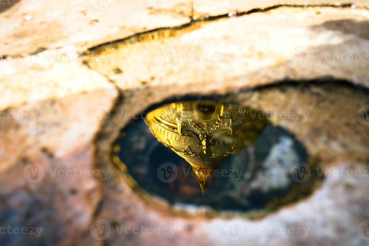 Reflection of Shwezigon Pagoda in the little water hole, one of the attraction of the pagoda, Bagan, Mandalay region, Myanmar photo