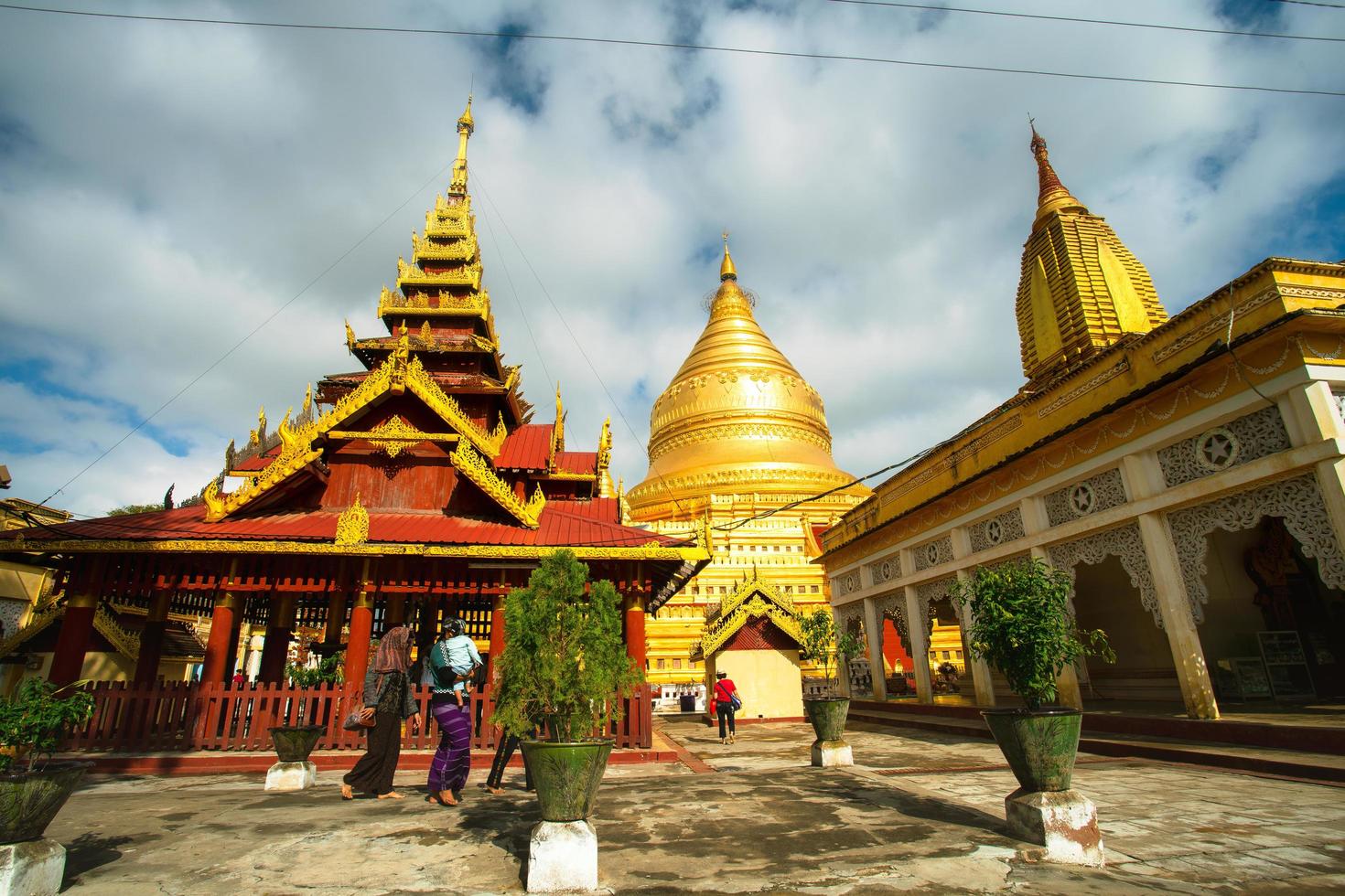 Bagan, Mandalay region, Myanmar - January 9, 2019 - Tourists visit at Shwezigon Pagoda, or Shwezigon Paya, a Buddhist temple located in Nyaung-U, a town near Bagan photo