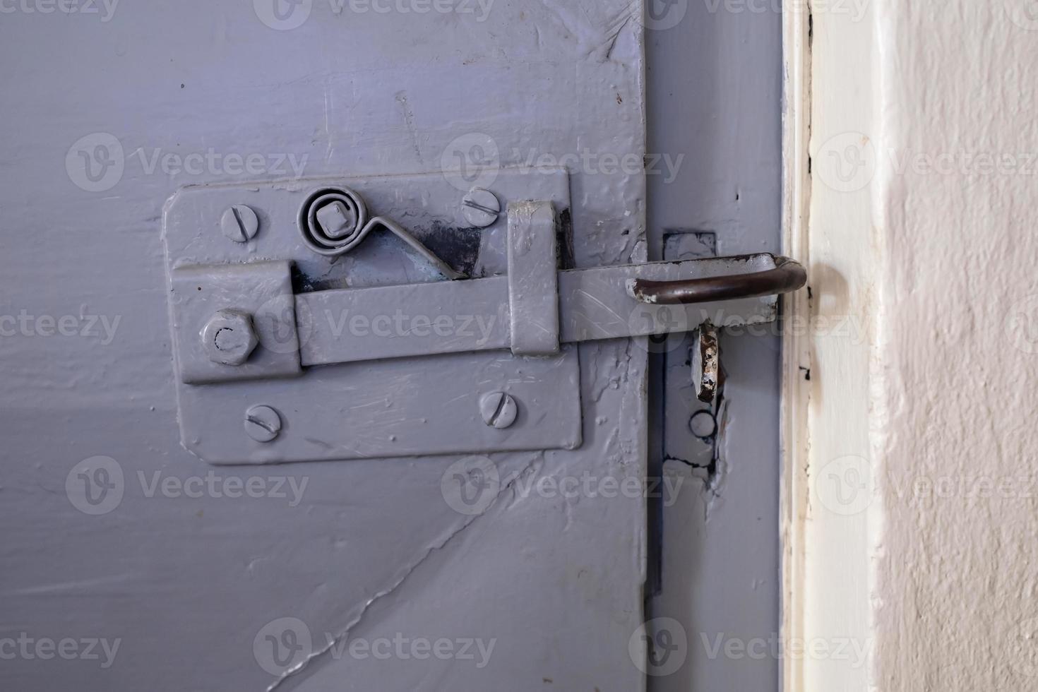 Retro latch on an iron door, indoors. photo