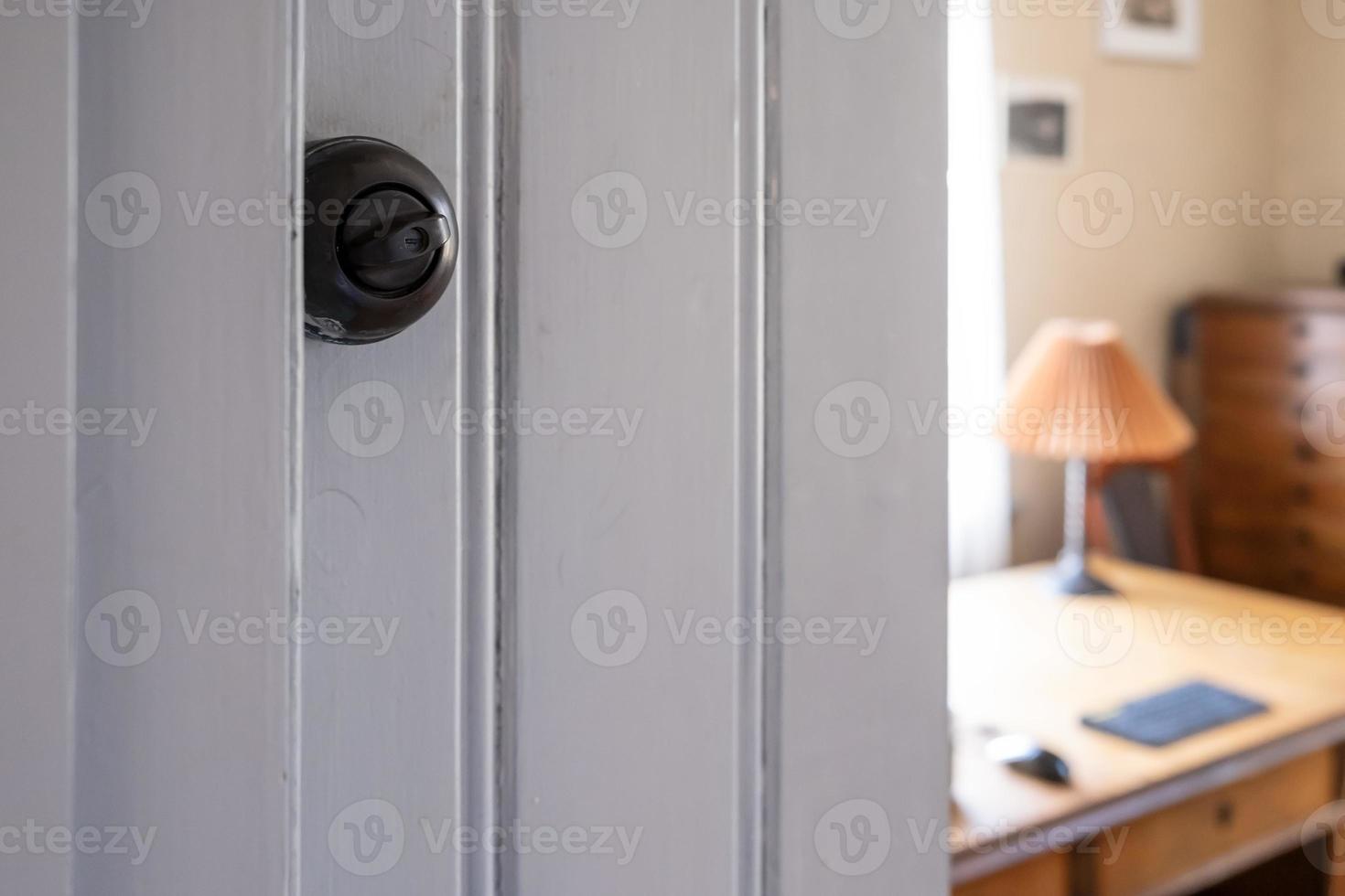 Old electric switch to be turned to turn the light on or off, against the backdrop of a cozy interior. photo