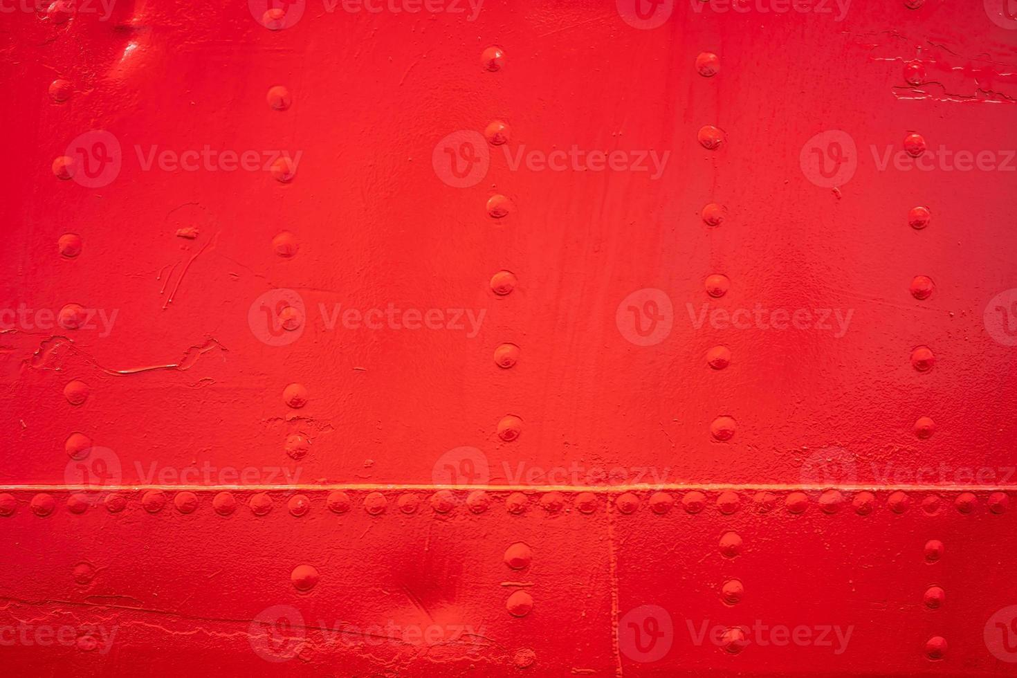 texture background with red metal wall with rivets photo