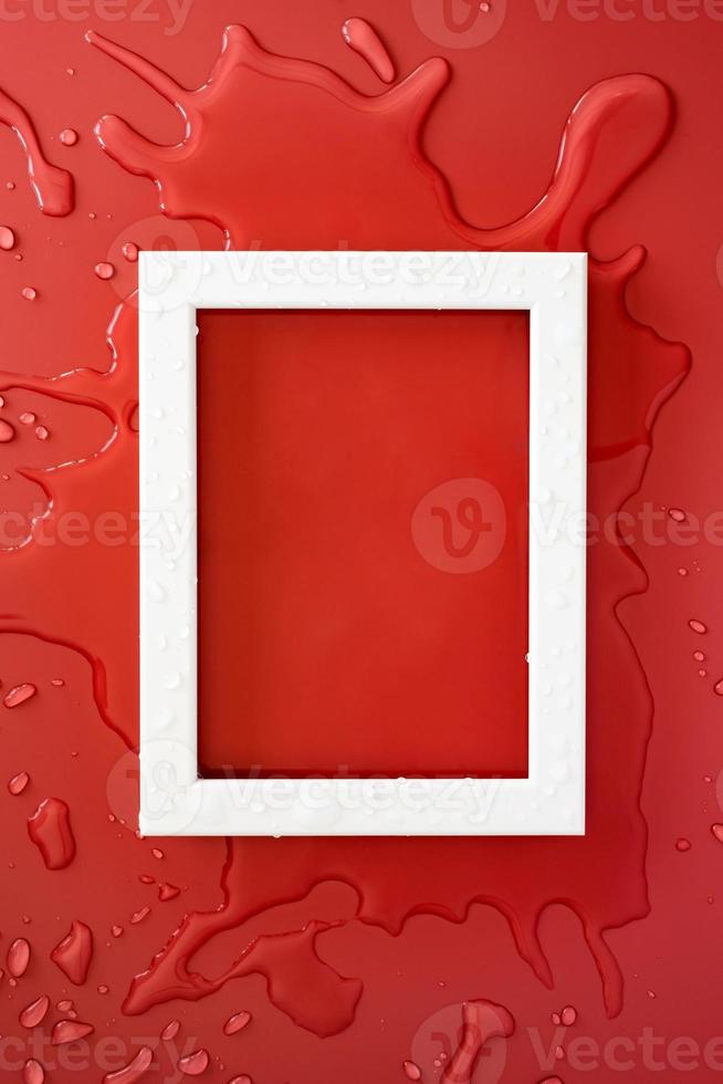 White rectangular empty frame on clean spilled water, on a red background. Copy space. Flat lay. Top view. photo