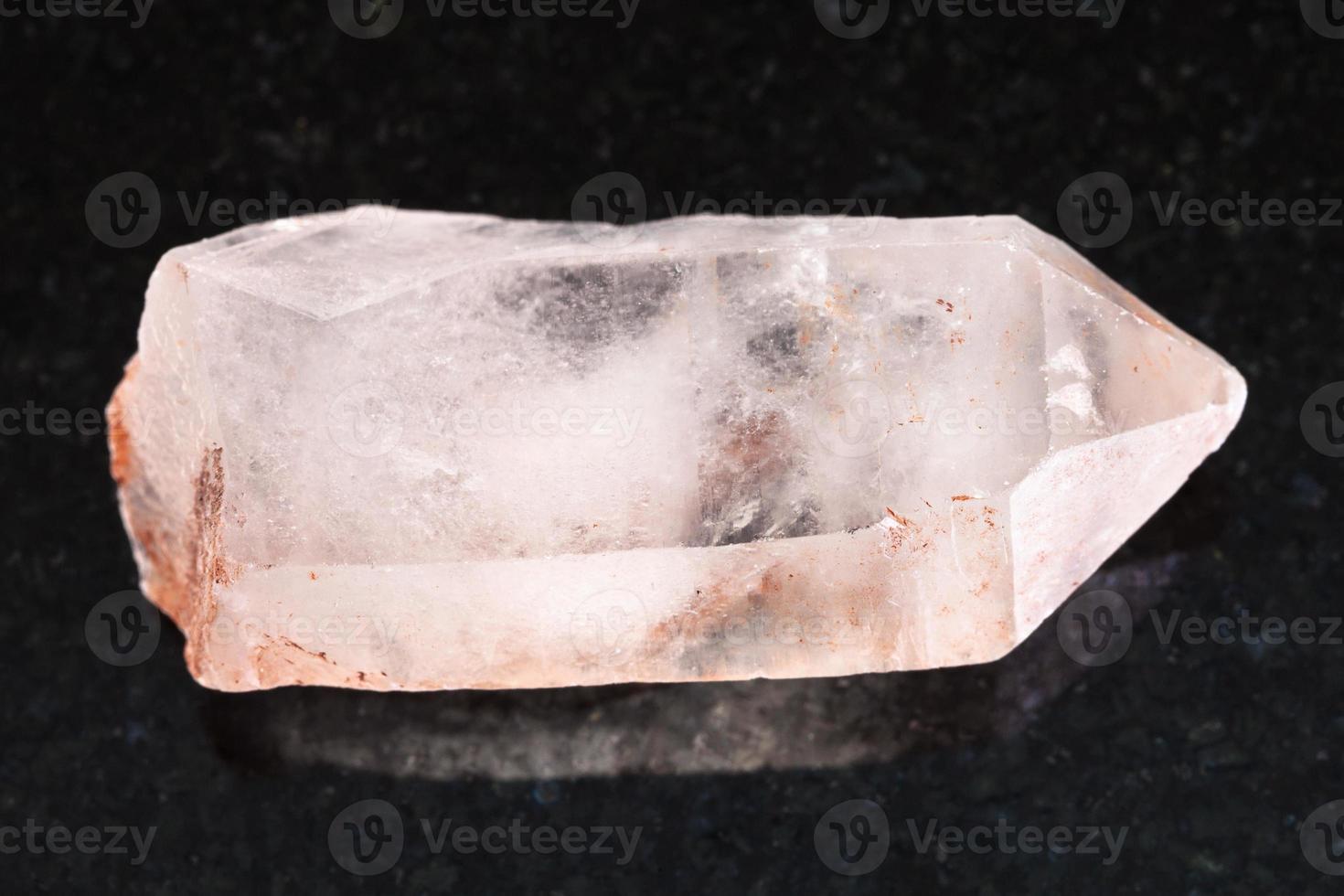 raw crystal of rose quartz gemstone on dark photo