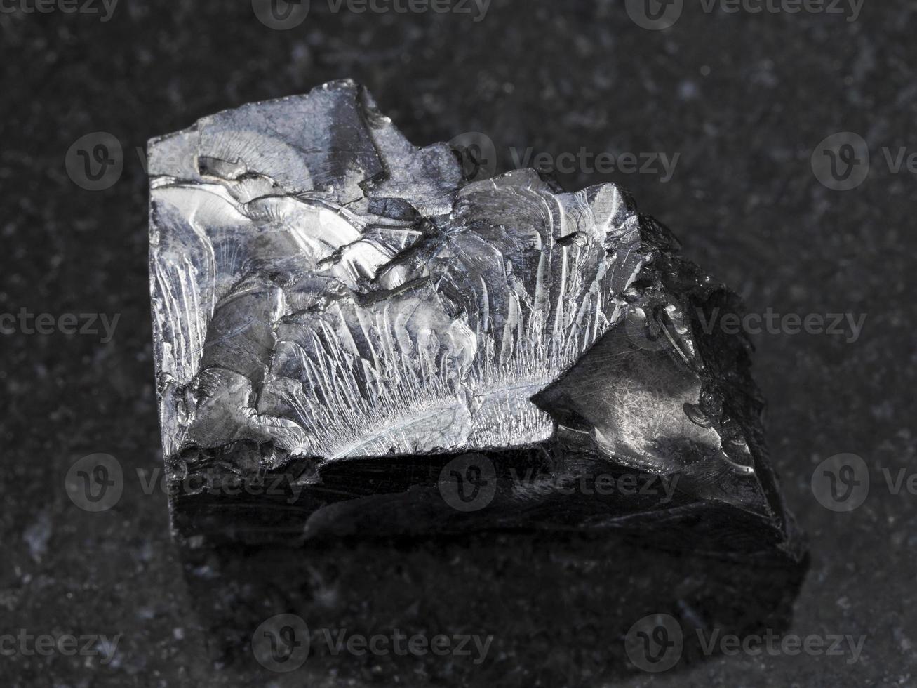 raw shungite stone on dark background photo