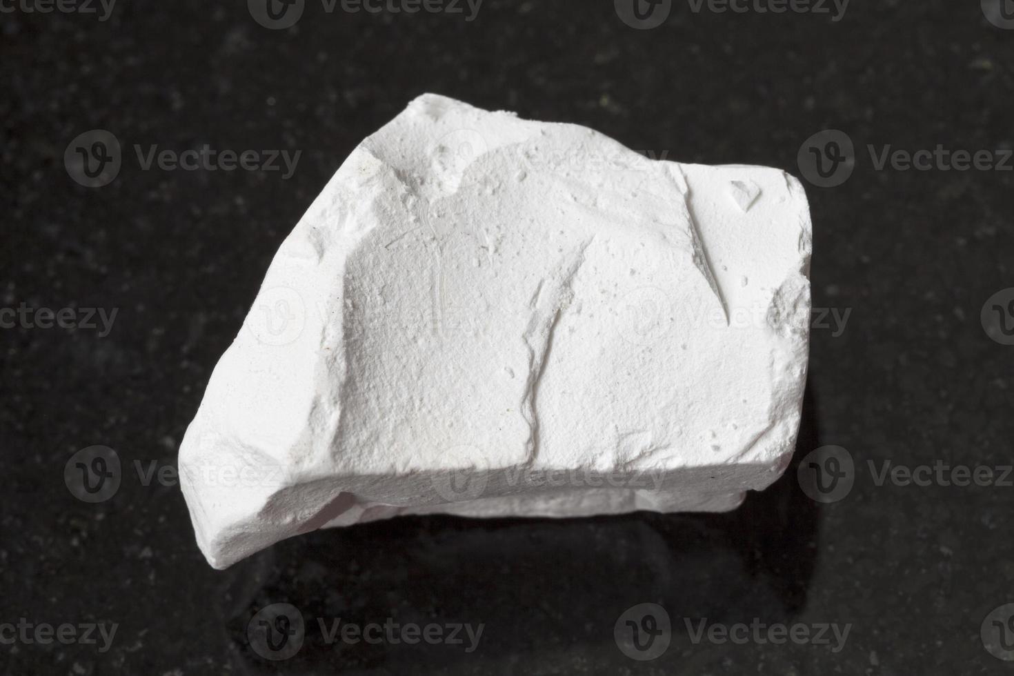 raw chalk stone on dark background photo