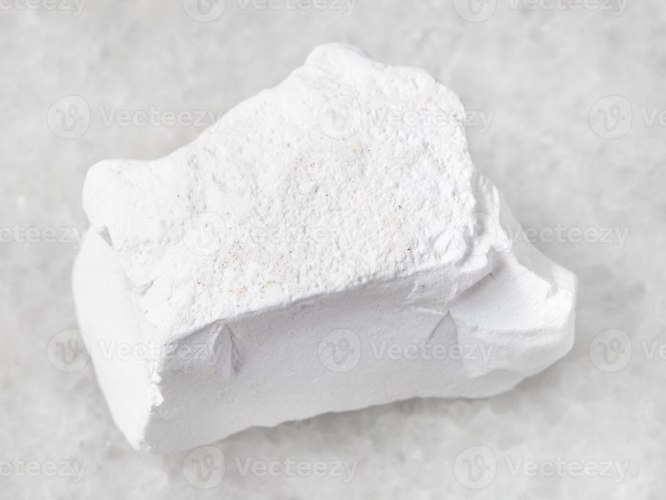 rough chalk stone on white photo