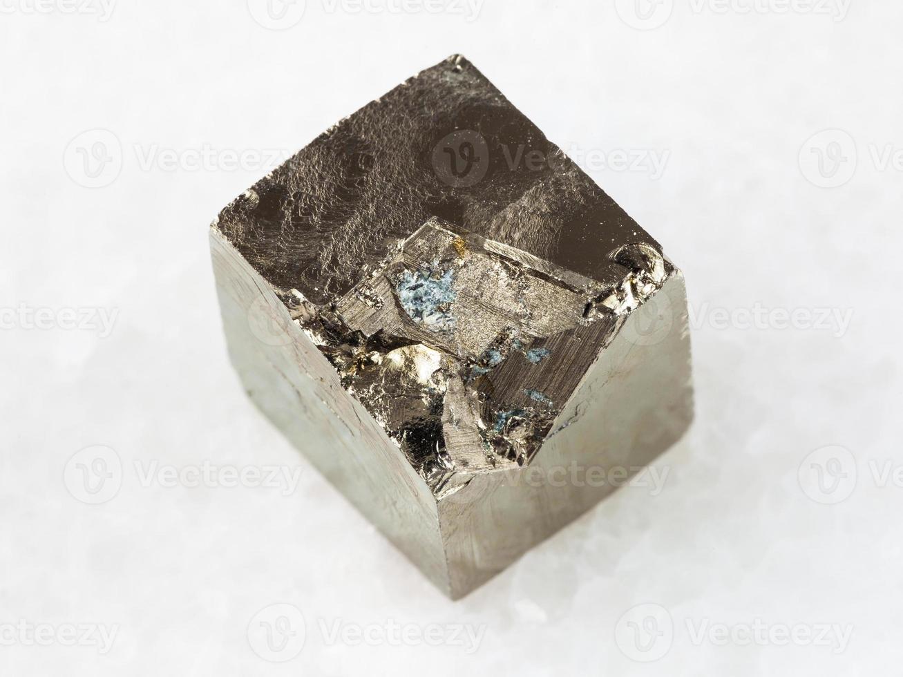 raw pyrite crystal on white marble photo