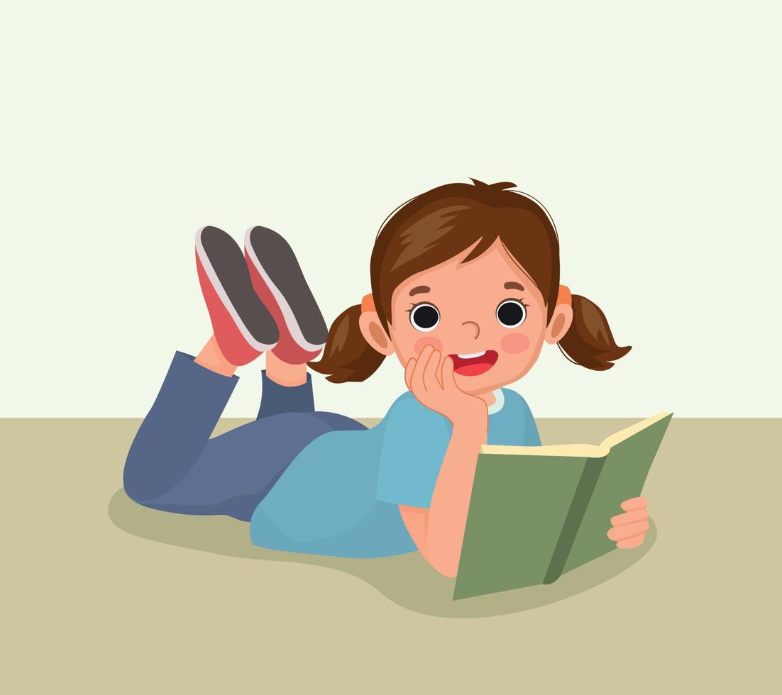 linda niña leyendo un libro tirado en el suelo vector