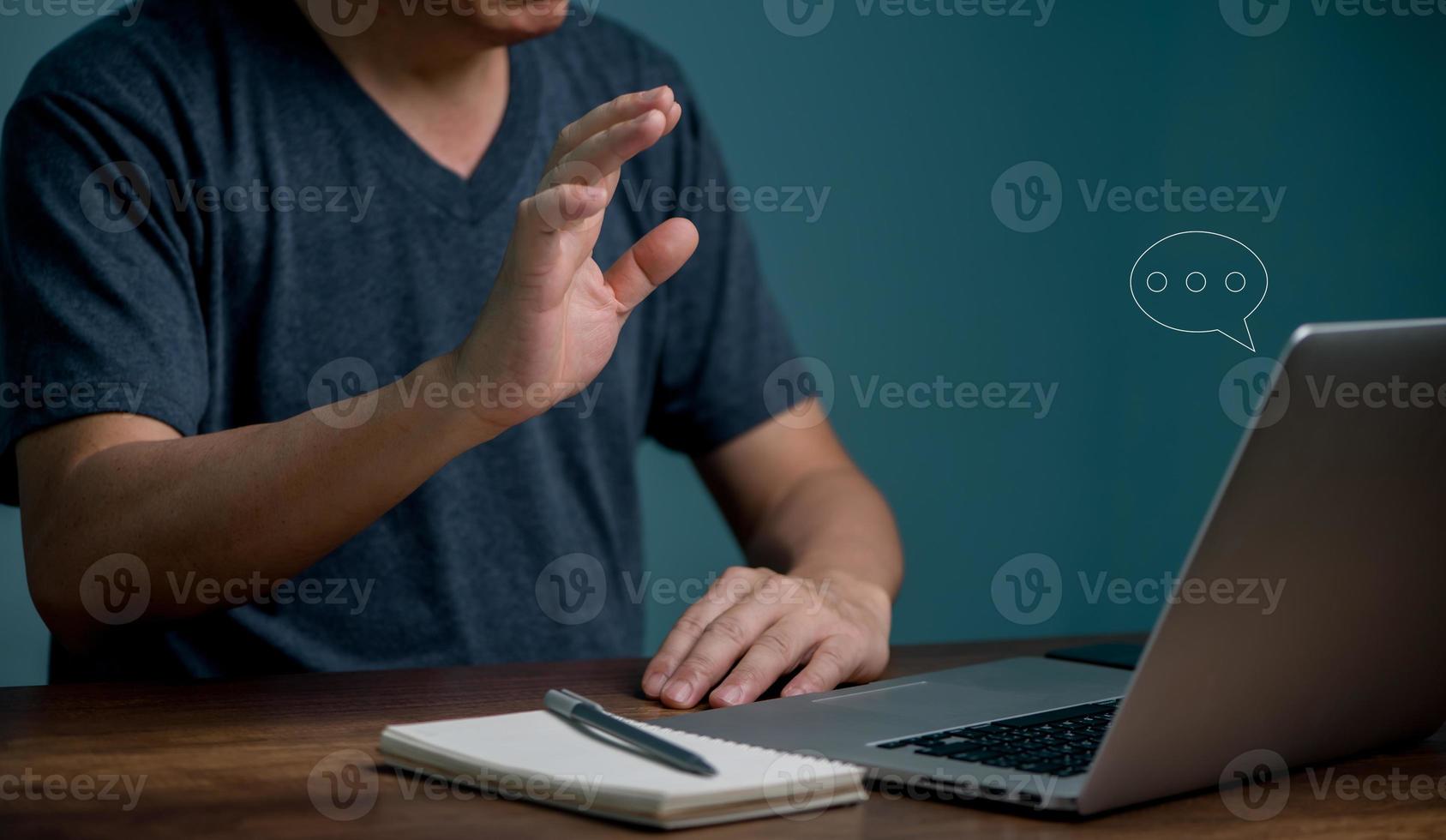 Young man learning online class and meeting online by using laptop computer and writing on notebook, E-learning and online communication concept. photo