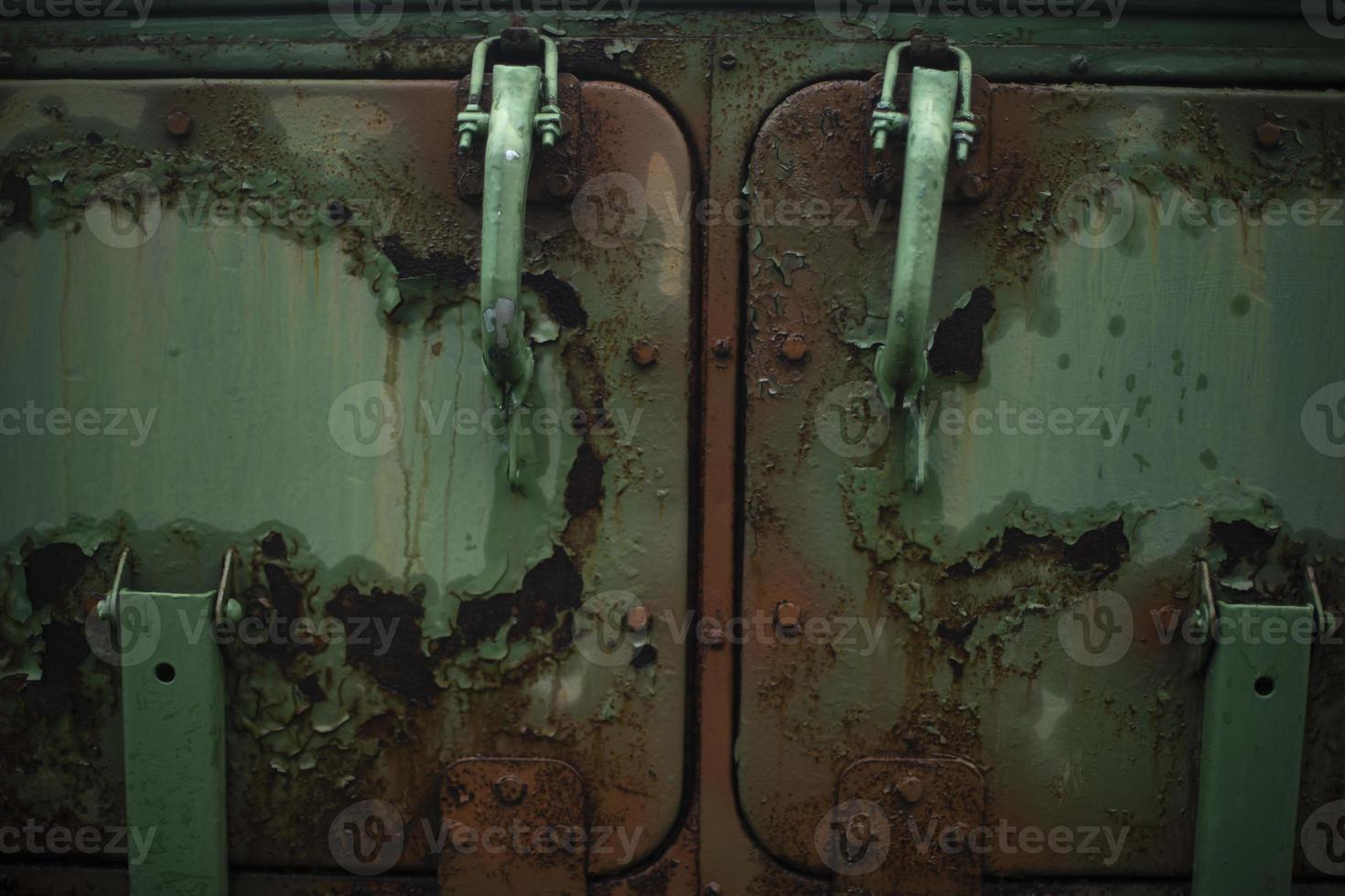 Rust on metal. Field kitchen door. Rust on green paint. Old machine in detail. photo
