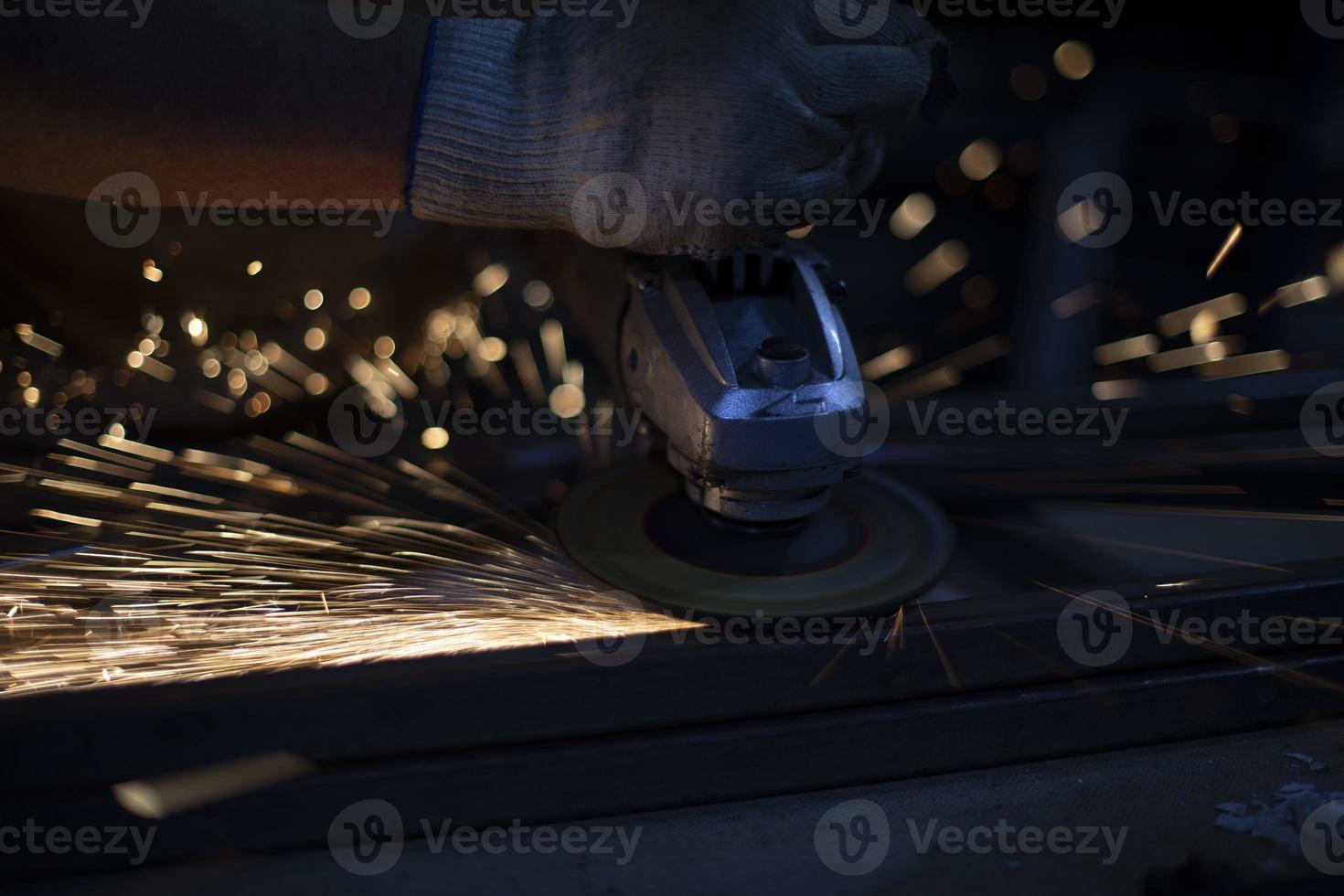 Grinding of steel. Sparks from metal. Hot particles. photo