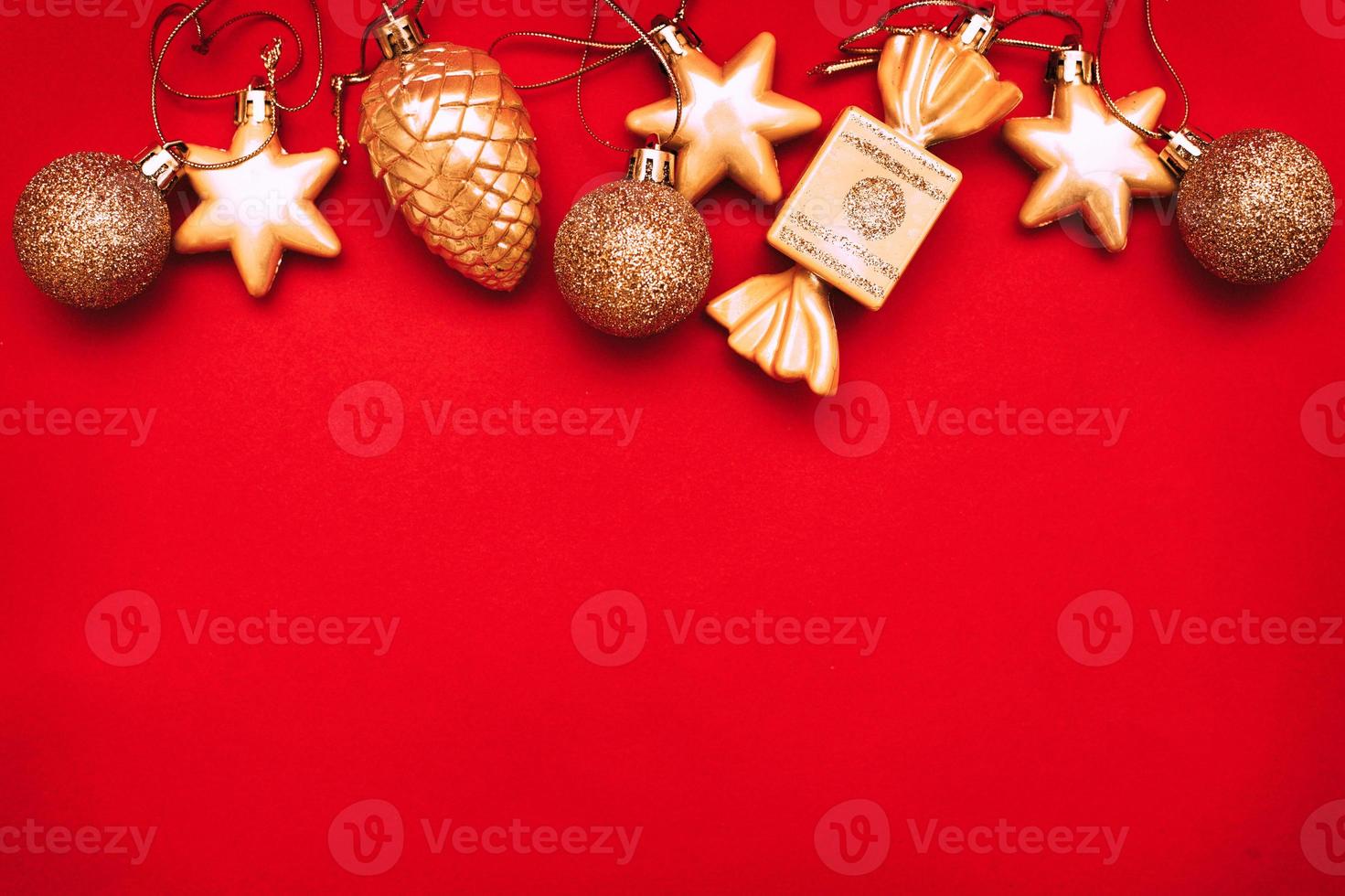 Gold Christmas balls and toys on a red background photo