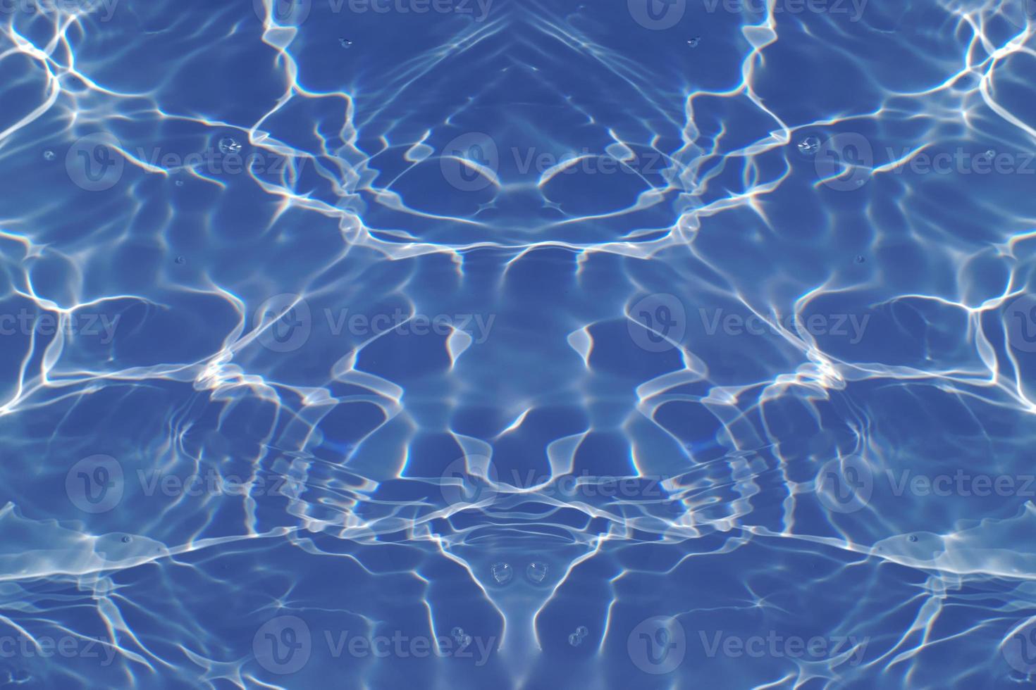 Defocus blurred transparent blue colored clear calm water surface texture with splashes and bubbles. Trendy abstract nature background. Water waves in sunlight with copy space. Blue watercolor shining photo